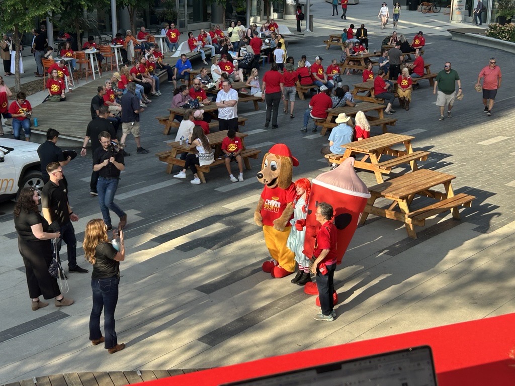 a high angle shot of a large crowd mingliing outside