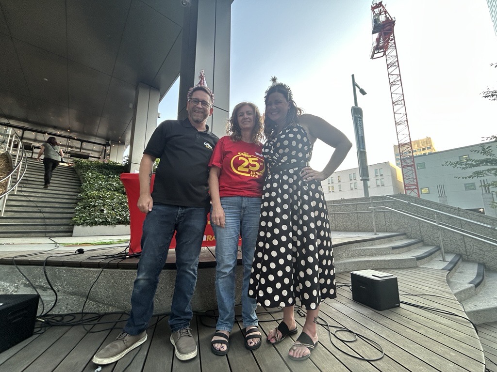a man and 2 women pose for a photo