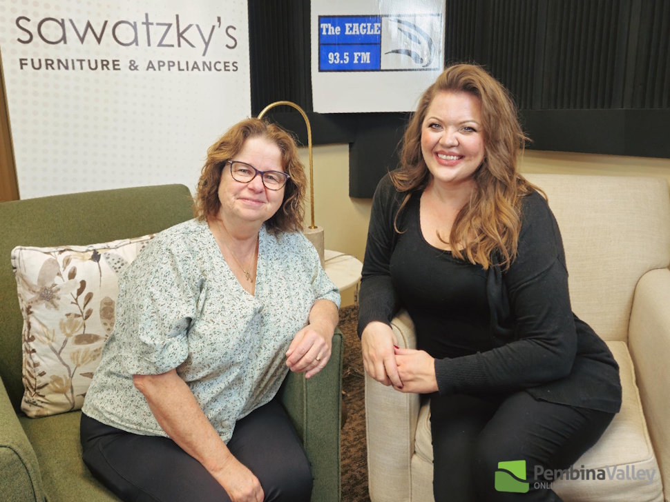 two women sit in a studio 