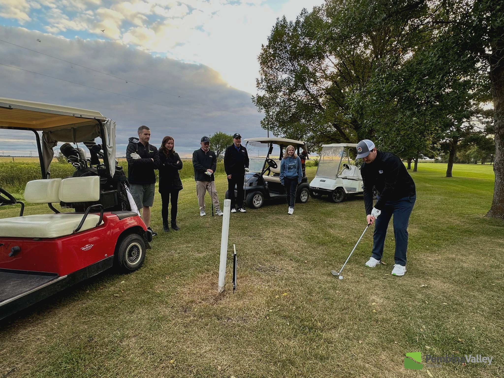 Garrett Dick (Earl's grandson) teeing off with his team behind at Oakview Golf & Country Club