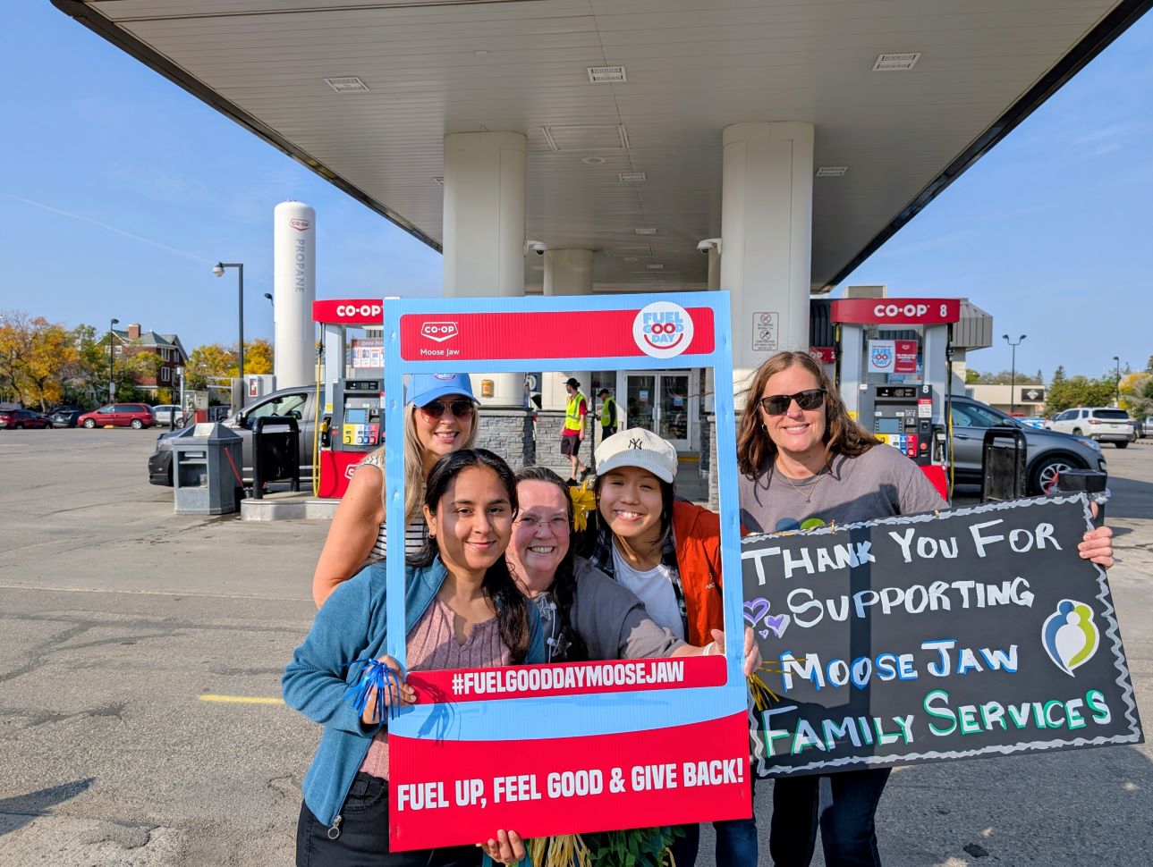 Michaela Turner (back, leftmost) and Tara Jones (rightmost) with Family Services staff, greeting customers at the 1st Ave Co-op Gas Bar (photo by Gordon Edgar)