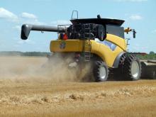 new holland combine harvesting a field of wheat