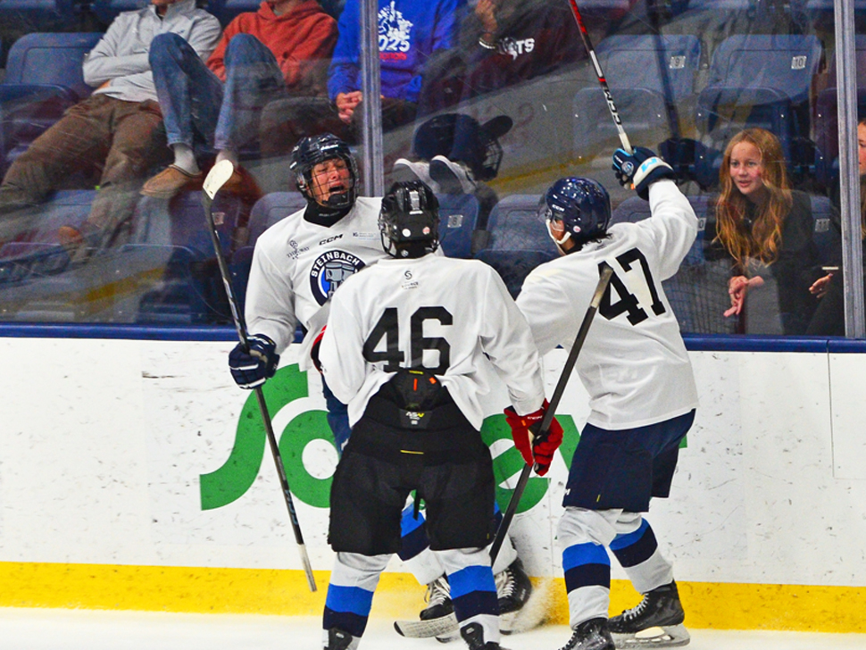 Pistons players celebrate after scoring a goal in a preseason game