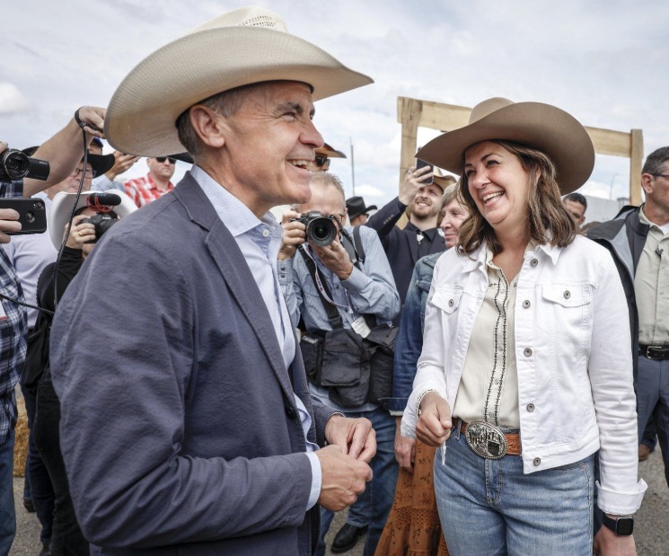 Prime Minister Mark Carney, left, meets with Alberta Premier Danielle Smith as the pair attend a Stampede breakfast in Calgary, Alta., Saturday, July 5, 2025. THE CANADIAN PRESS/Jeff McIntosh