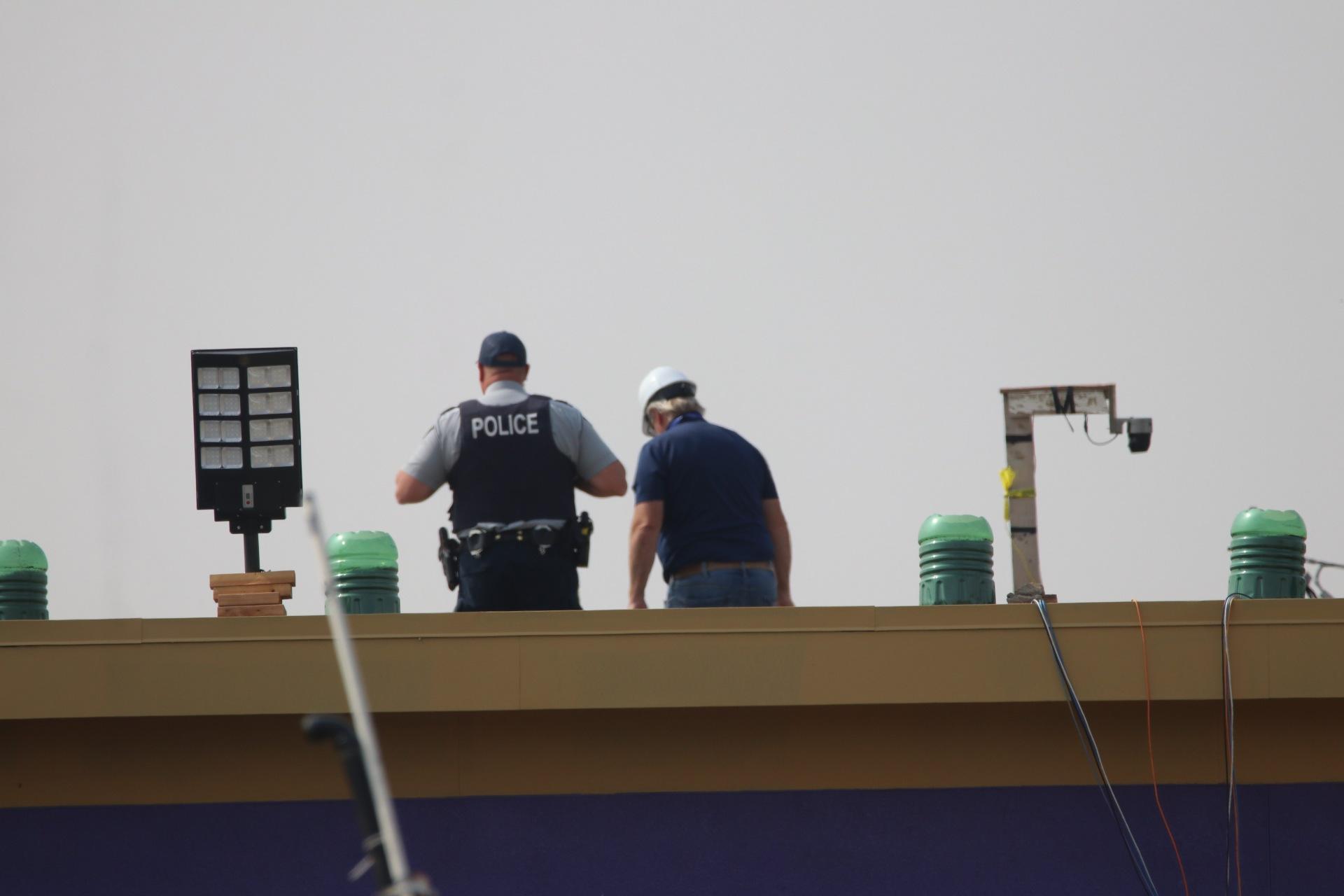 An RCMP officer and a civilian worker on top of the former Richmound School. (photo by Jenny Hagan)