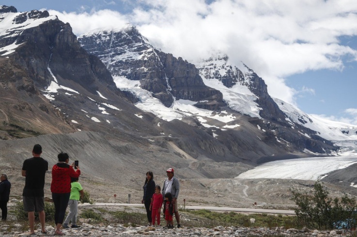 Tourists take photos at the Columbia Icefields near Jasper, Alta., Sunday, July 19, 2020. THE CANADIAN PRESS/Jeff McIntosh