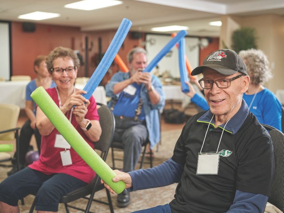 A photo of seniors playing a pool noodle game on chairs. (Alzheimer's Society of Manitoba)
