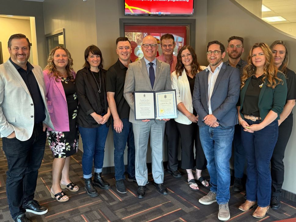 The staff of Goldenwest and CHVN alongside the mayor of Winnipeg, Scott Gillingham, after he presented them with a Community Service Award for 25 years on the radio. 