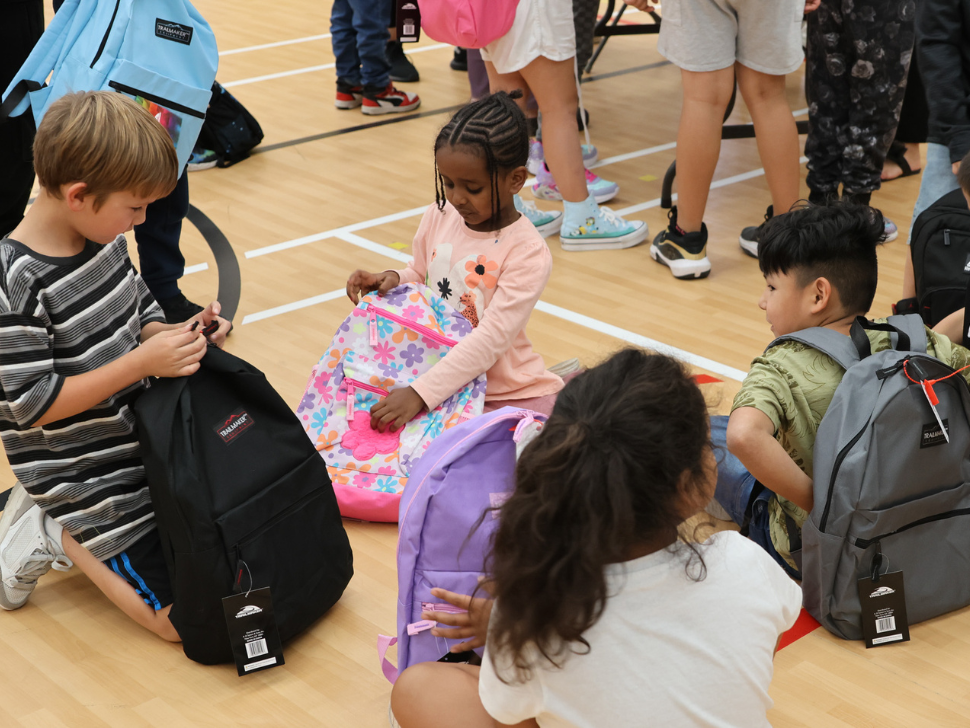 Students at David Livingstone School receive backpacks filled with school supplies