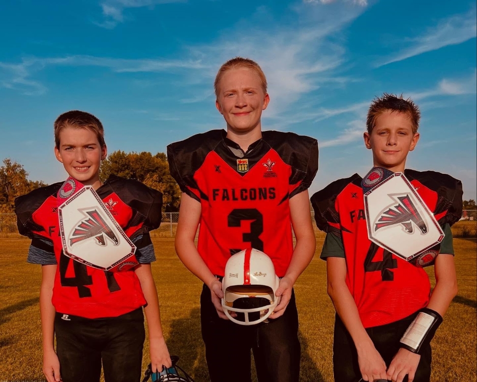 Three fotball players holding championship belts