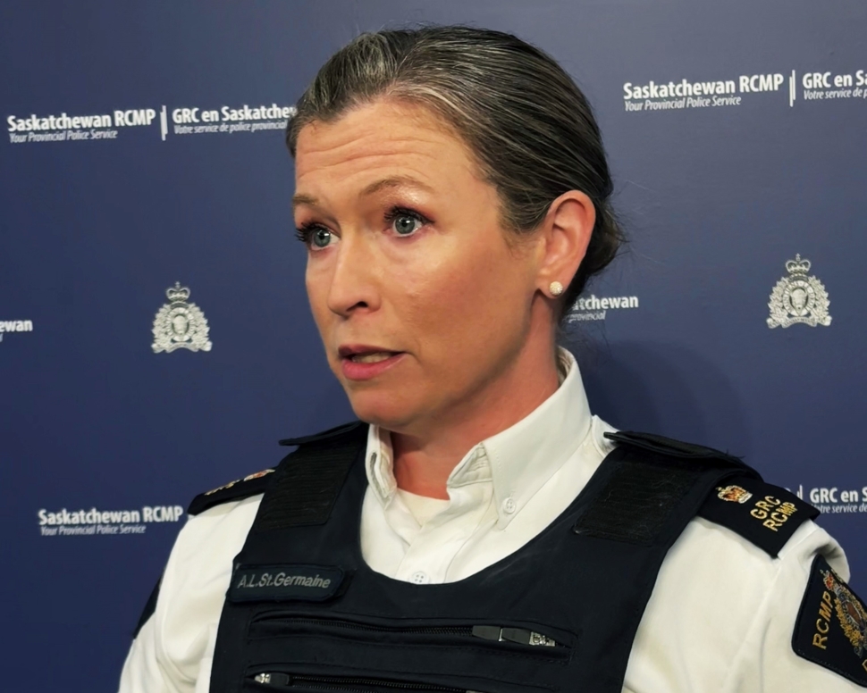 A female police officer standing in front of a blue background