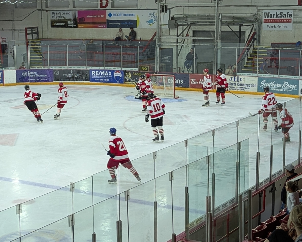 Hockey players in red and white jerseys playing a game