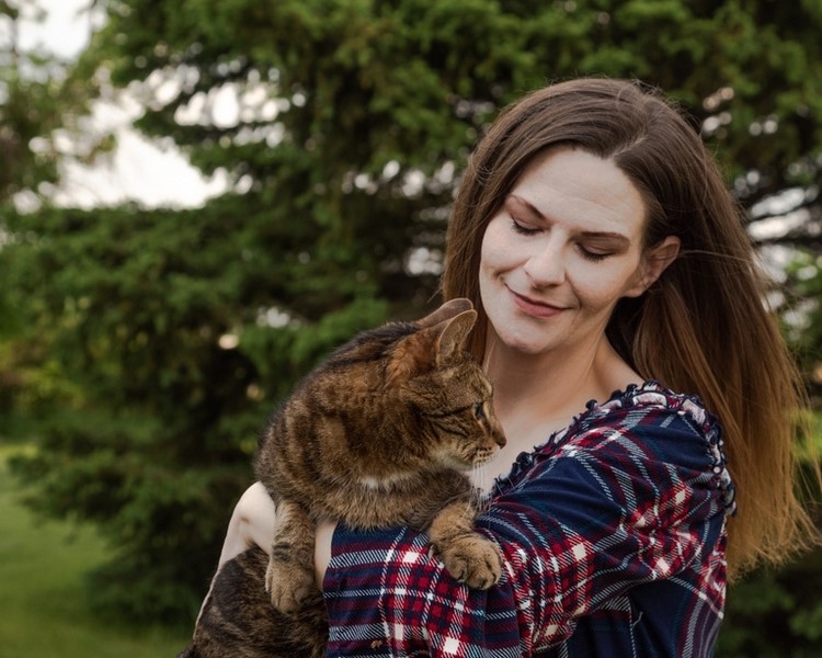 A woman holding a cat