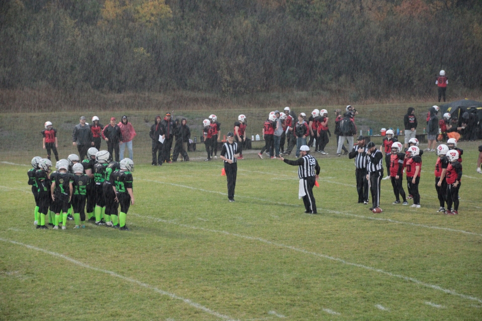 Football teams lining up in the rain