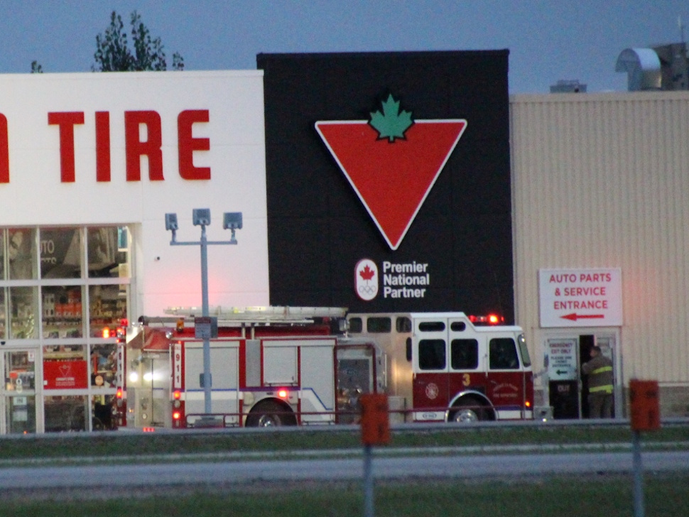 Portage la Prairie fire truck parked outside Canadian Tire early morning.