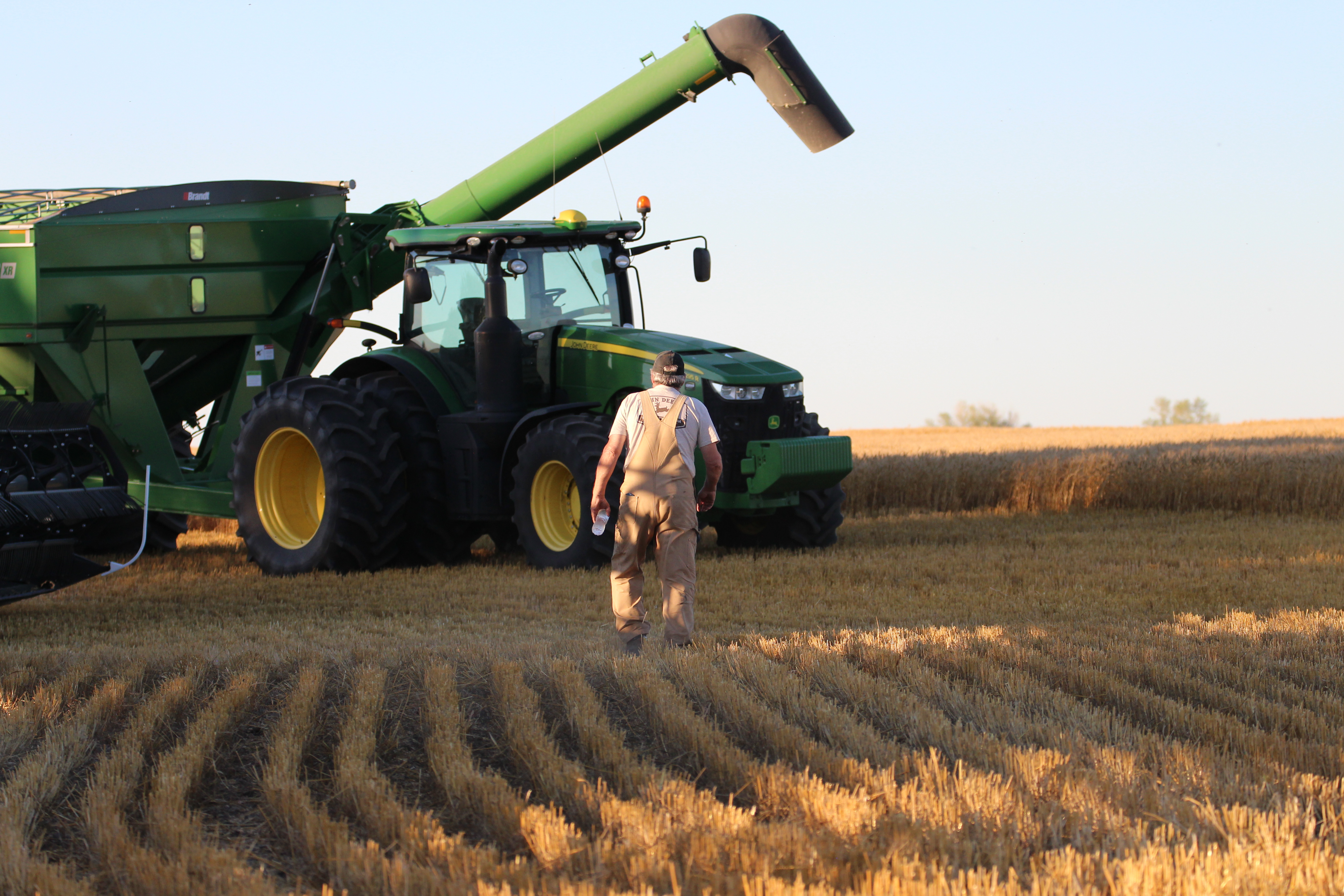A farmer walks to his tractor (FarmPhotos.ca)