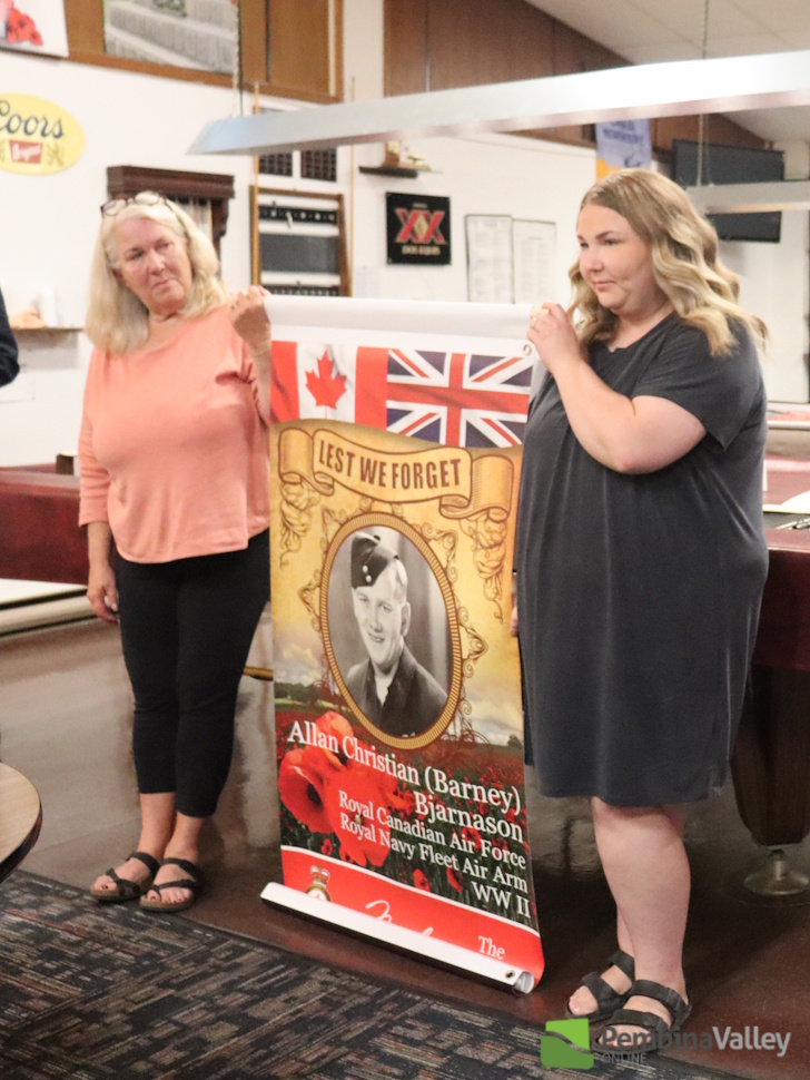 two people stand with a banner