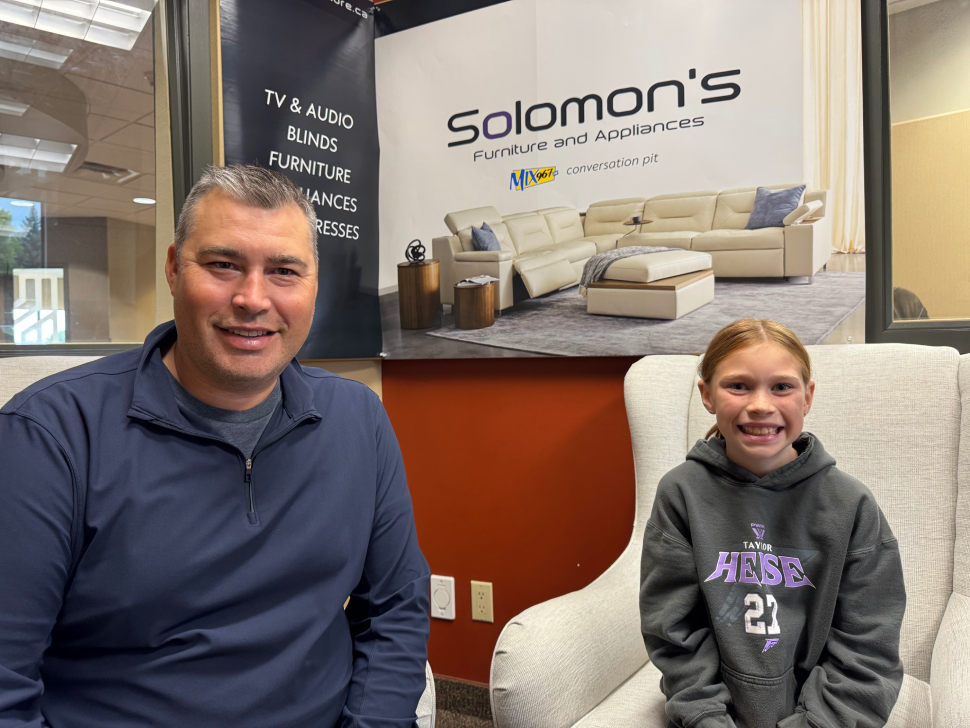Ryan Canada and his daughter, Everly in the MIX 96 studio, furnished by Solomon's in Steinbach.