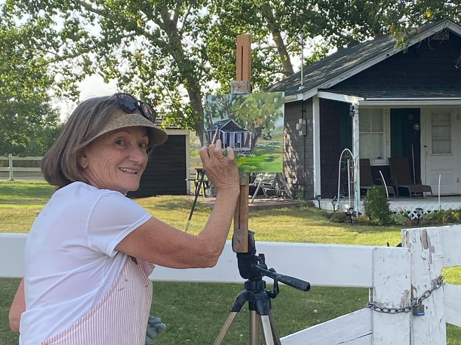 Woman painting a Rosebud landscape