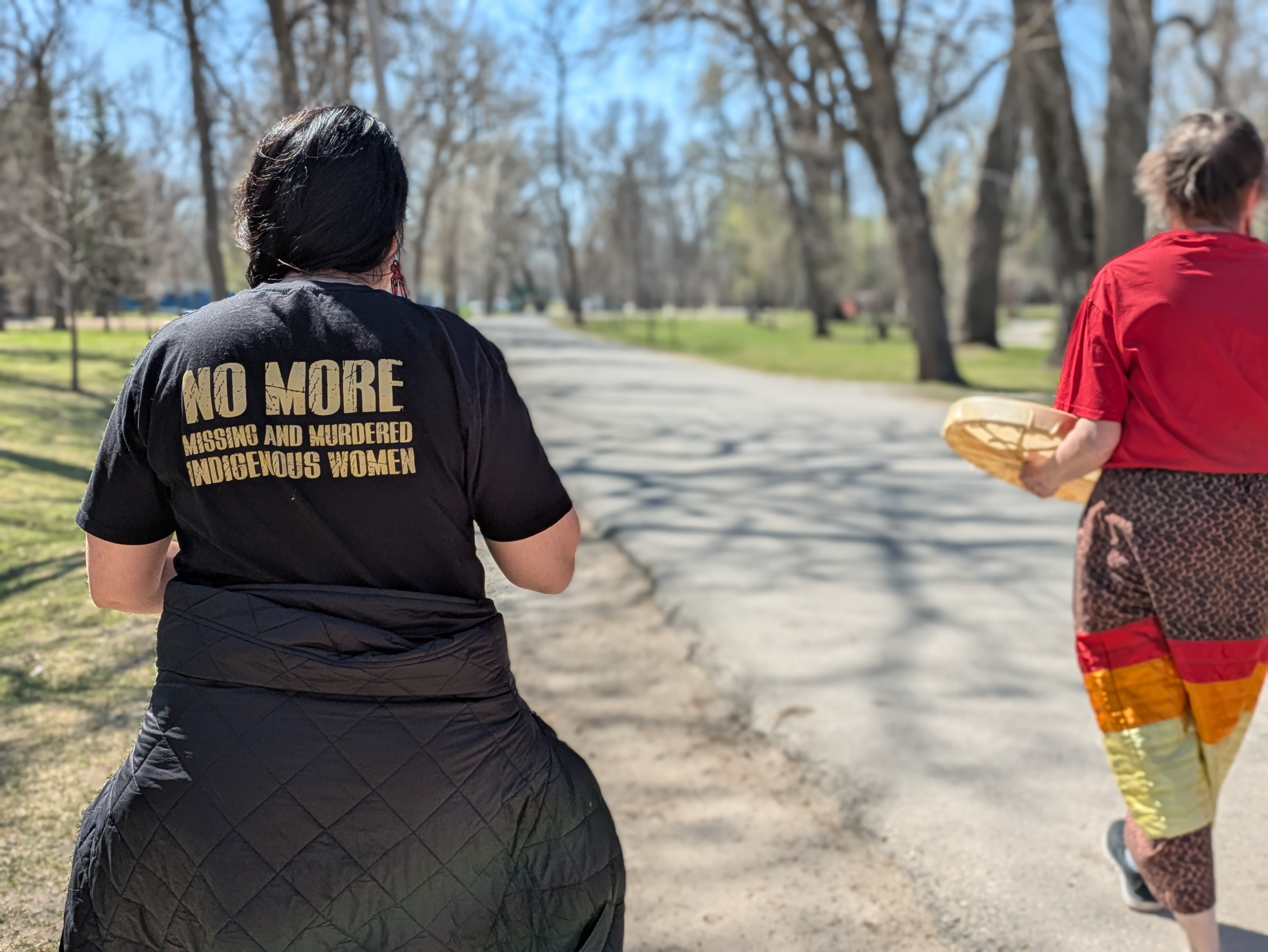 A member on the second annual Red Dress Day Walk wearing a shirt which reads 'no more missing and murdered Indigenous women'
