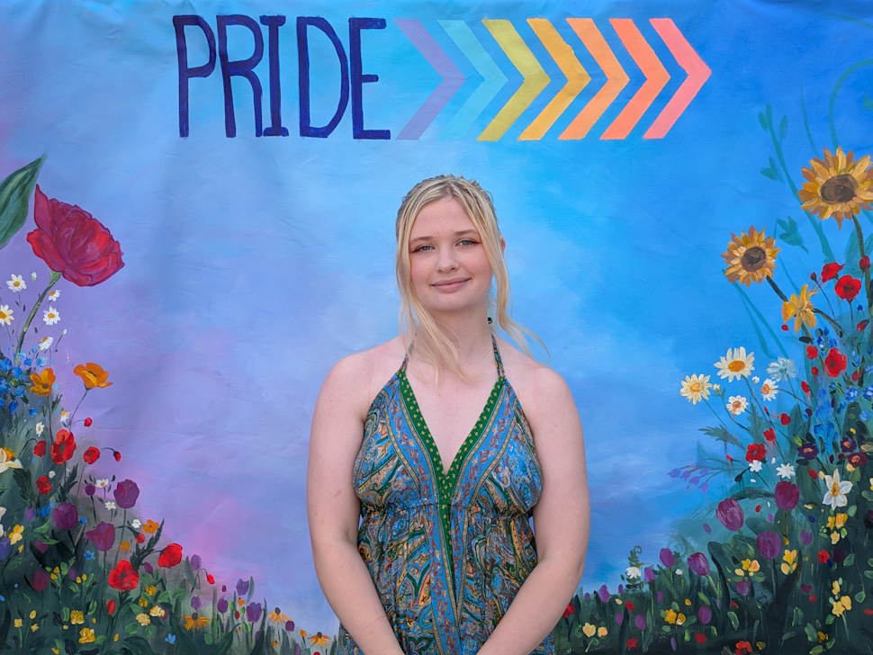 Samantha Martinussen, smiling in front of her hand-painted mural which she contributed to Portage Pride last weekend. PortageOnline/Maryssa McFadden