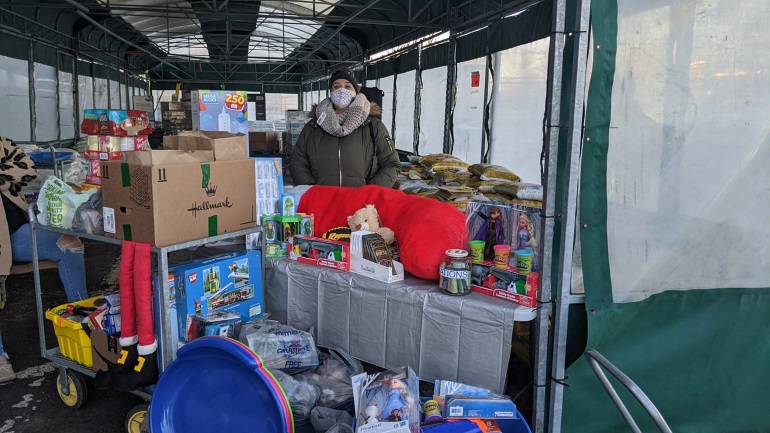 Allie surrounded by donated toys.