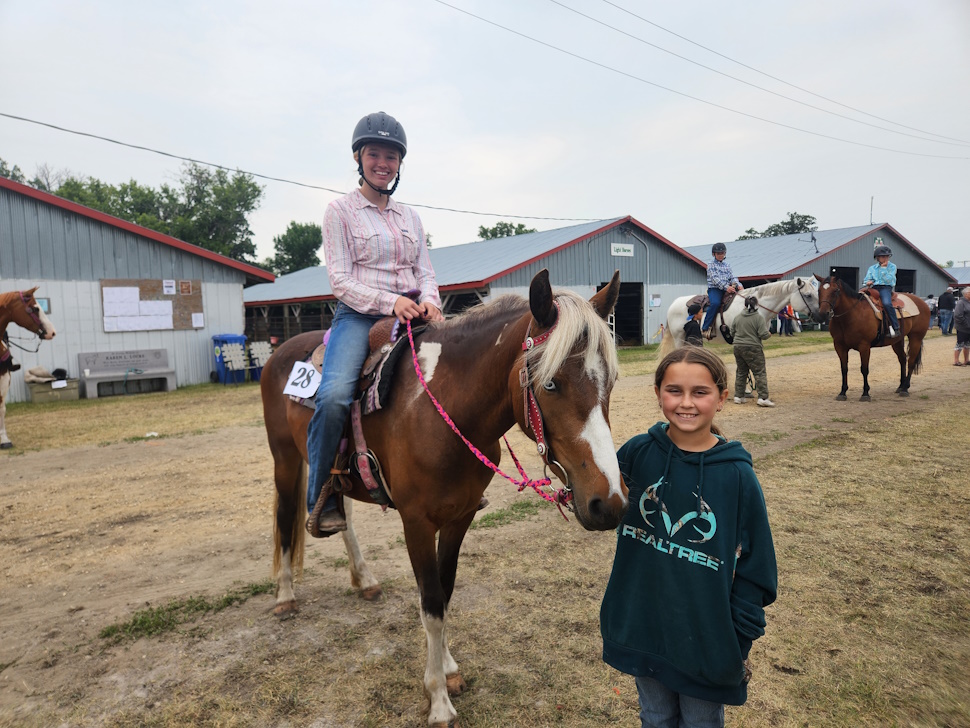 J.J Gates on her horse Montana, with her younger sister just after finishing her barrel run. PortageOnline/ Tristen Sokolosky