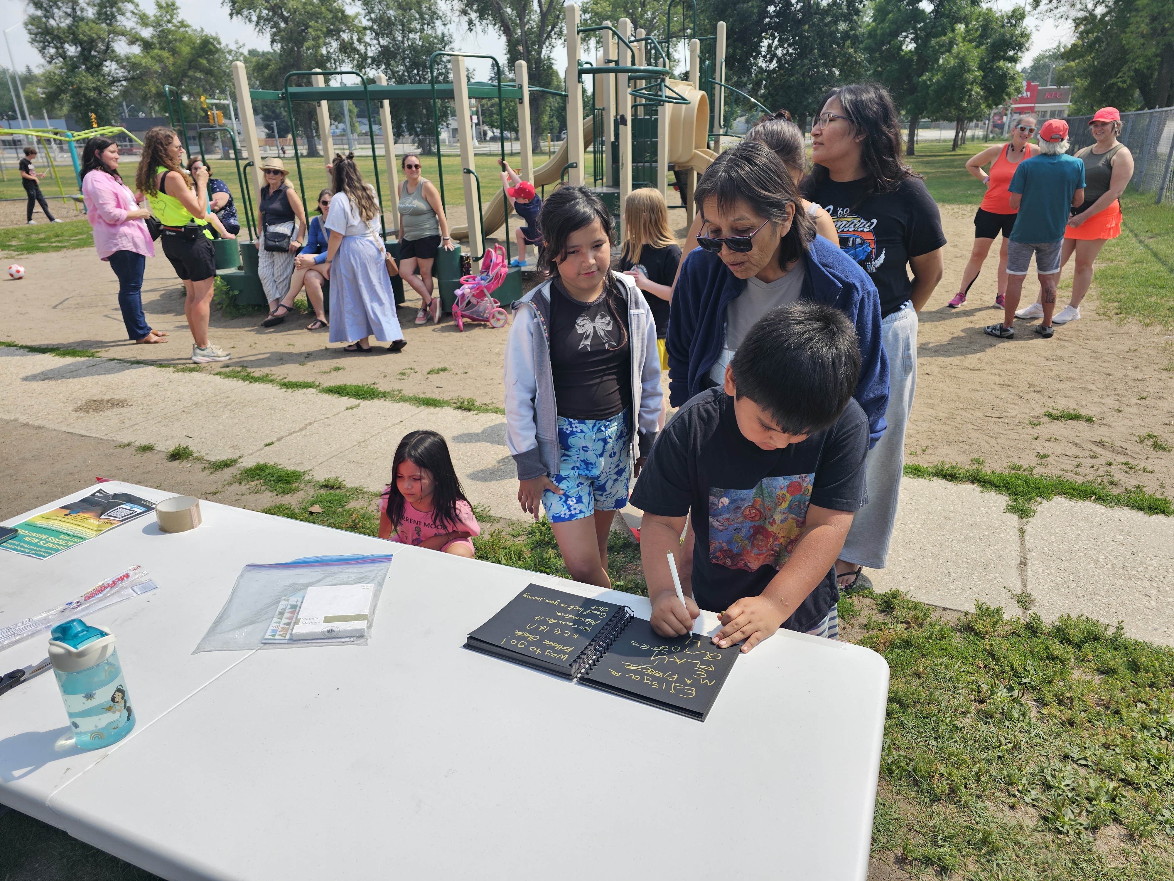 Wing's supporters line up to sign her notebook, full of well-wishes along her journey