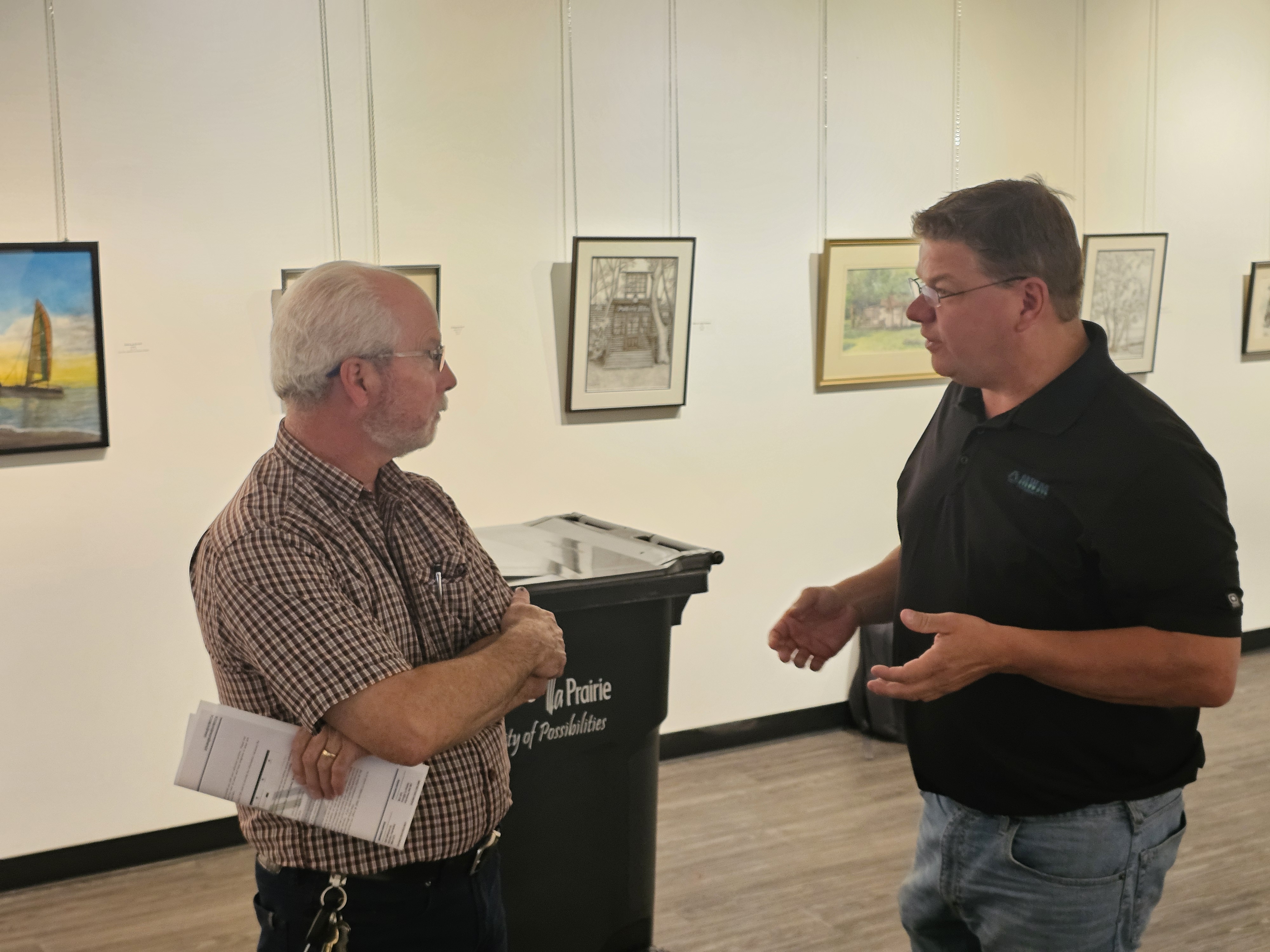 Shawn Samels with MWM Environmental talks to a local resident about the details of the new system coming into effect