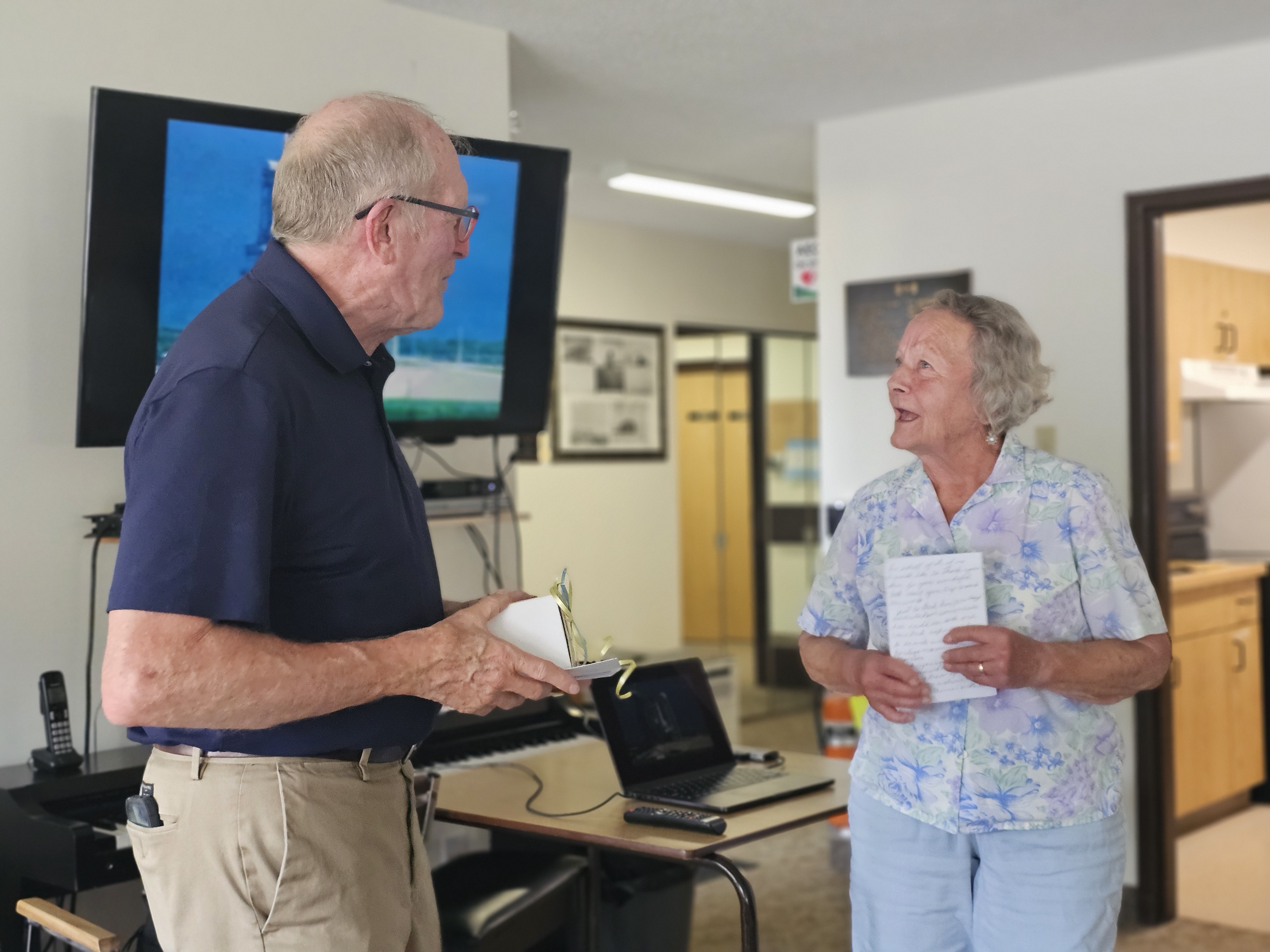 Gemar is presented with a card and gift box from the residents of Heritage Manor as thanks for taking the time to share with them