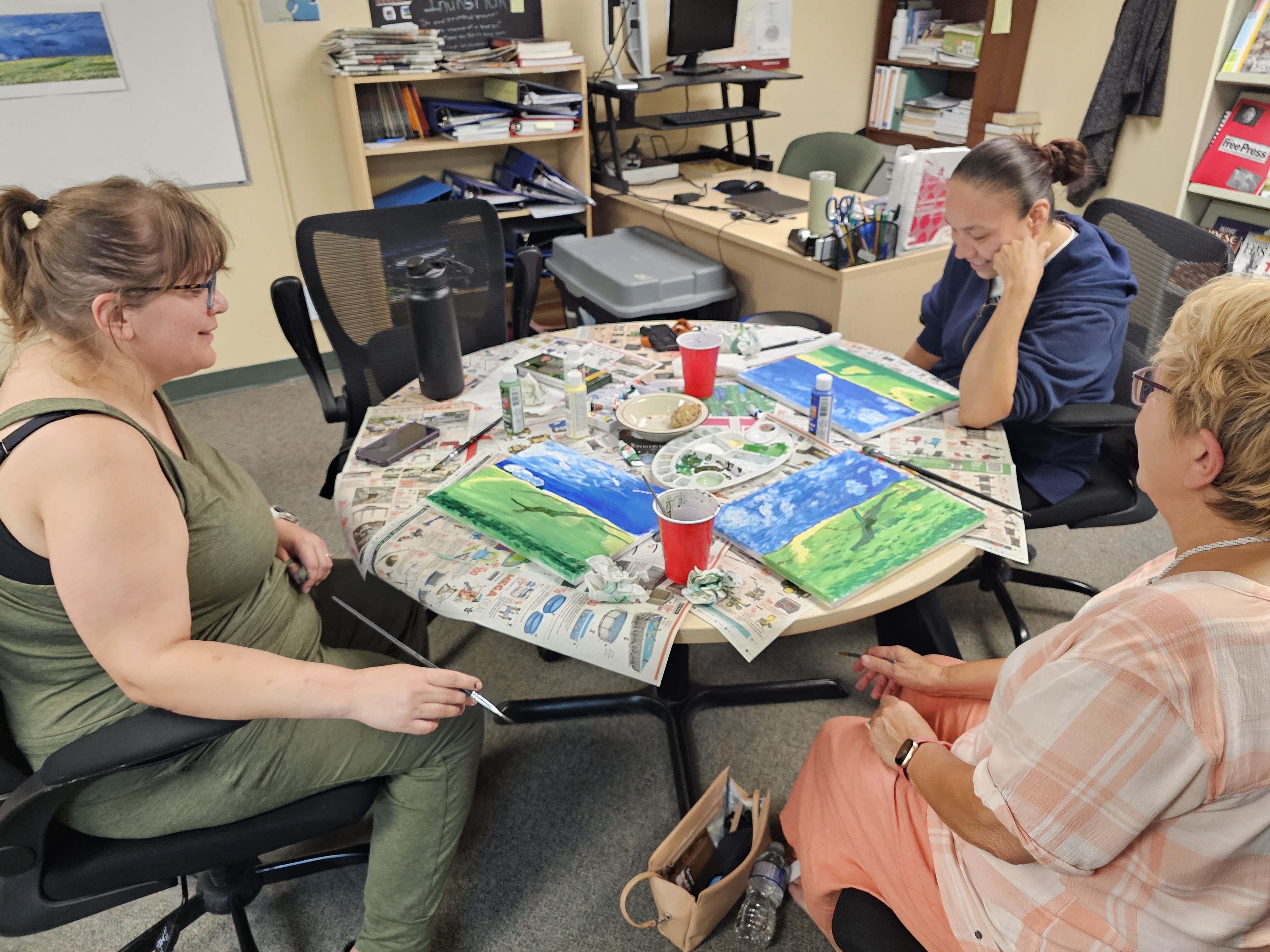The ladies gather around the tables for some good old painting fun
