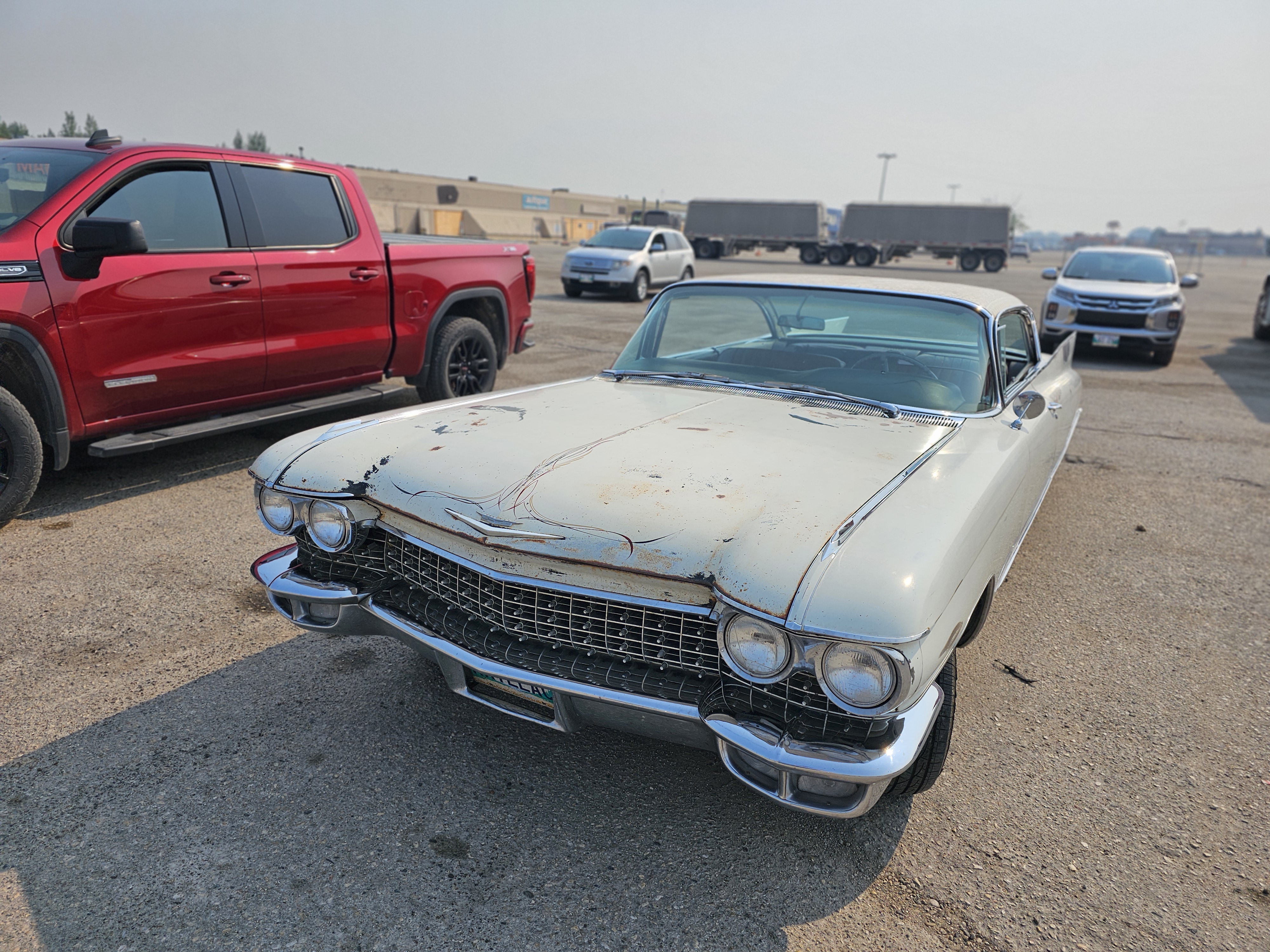 A striking white 1959 Cadillac, showcasing its iconic fins and a touch of vintage patina.