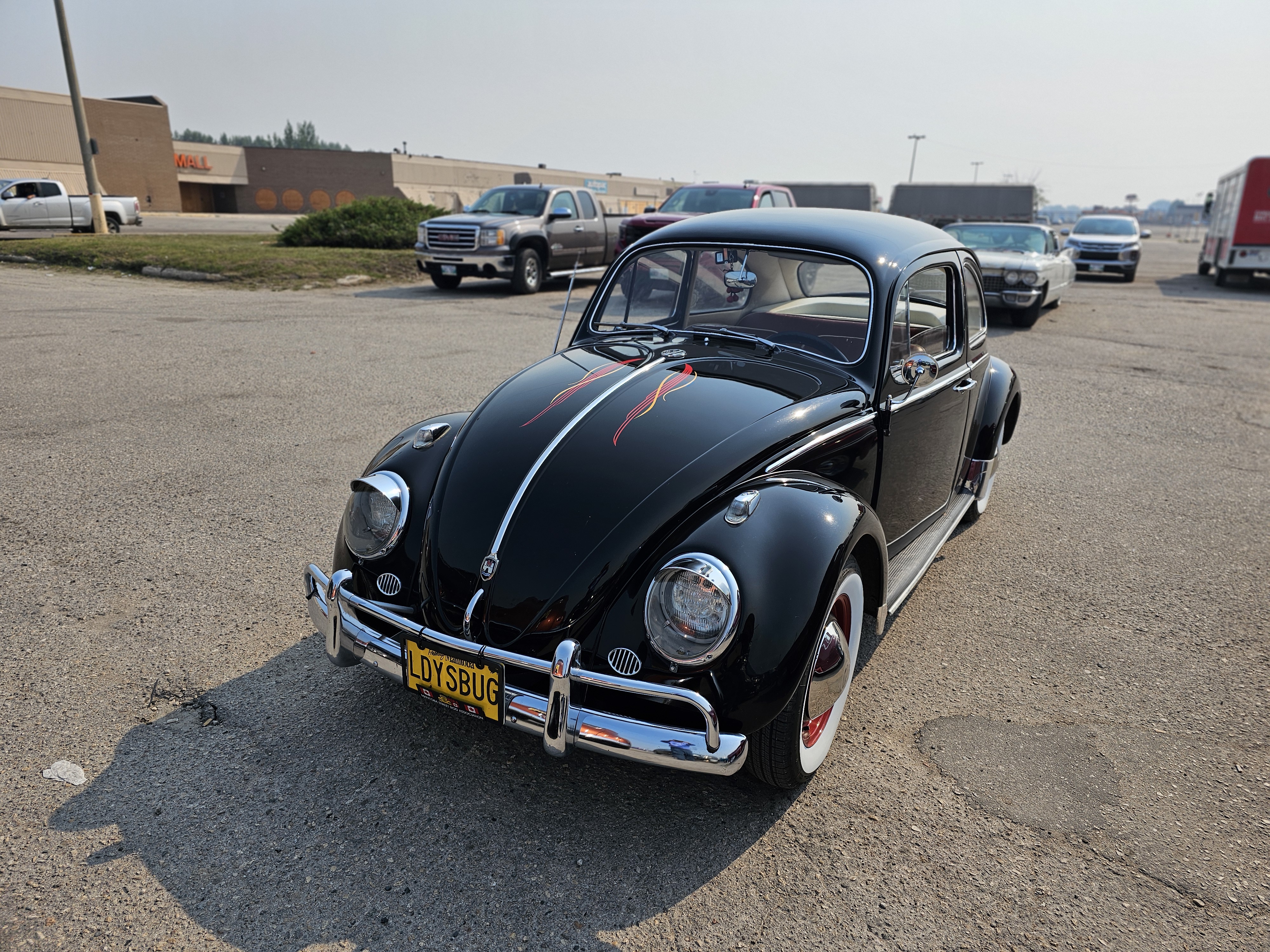 A classic black Volkswagen Beetle, complete with subtle flames on the hood.