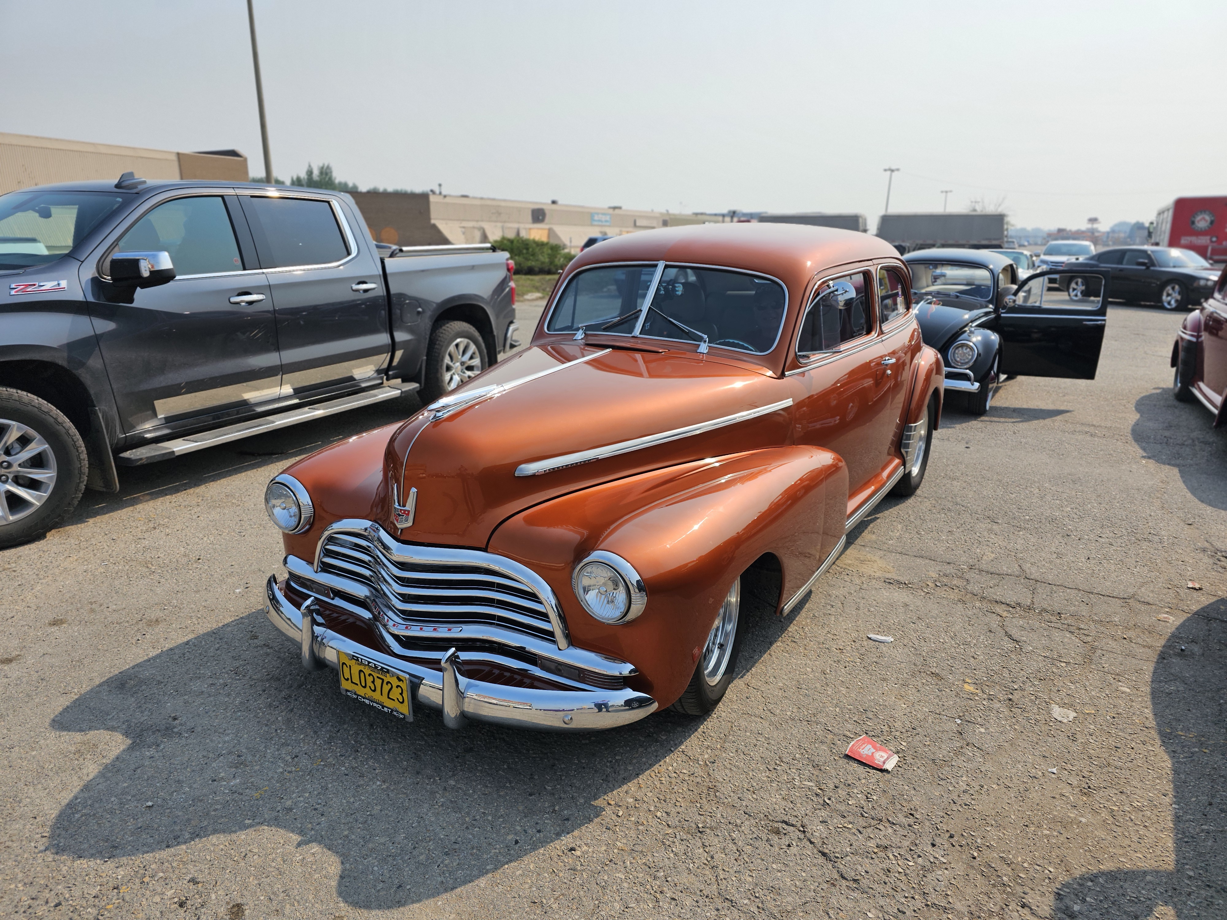 A gleaming copper-coloured 1940s Chevrolet, showcasing its streamlined design.