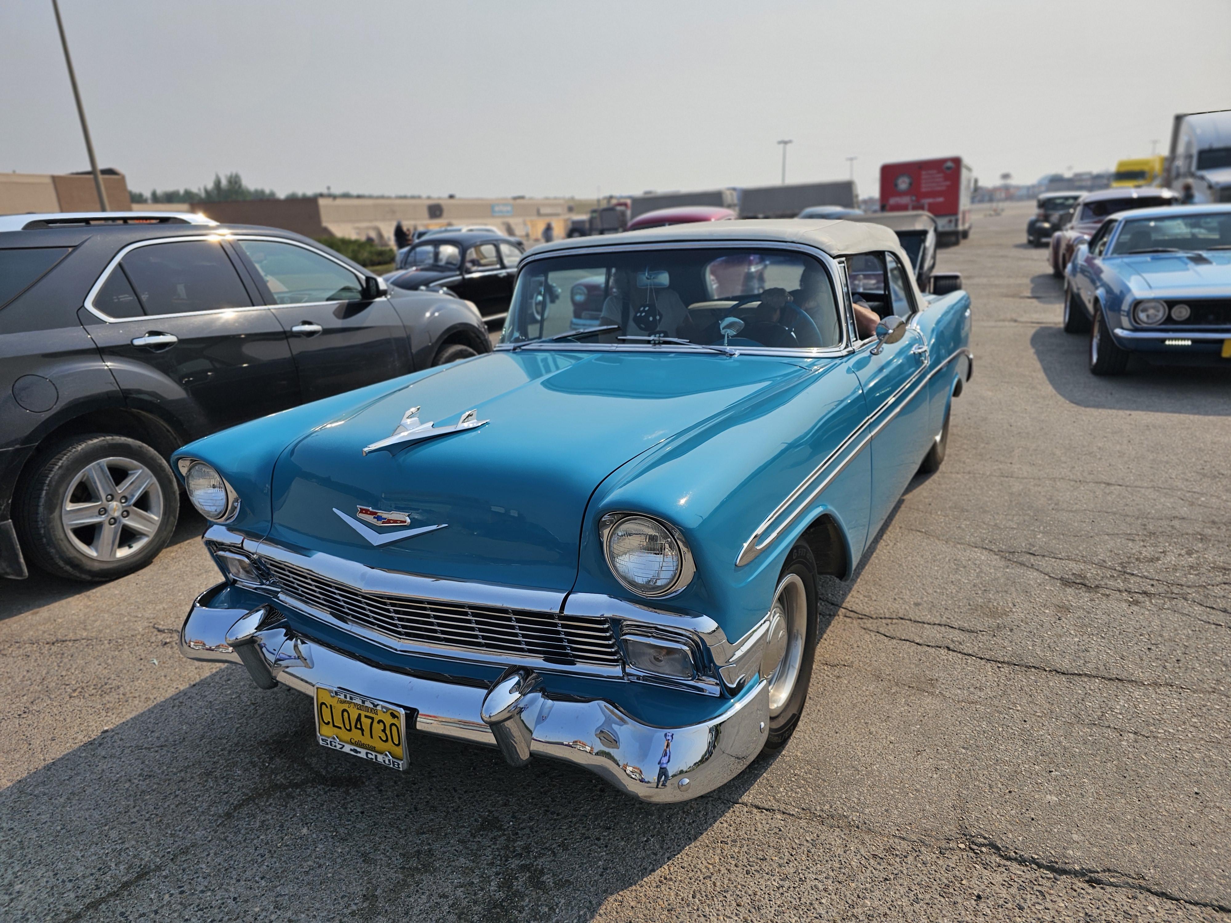 A vibrant blue 1956 Chevrolet convertible, perfect for a sunny drive.