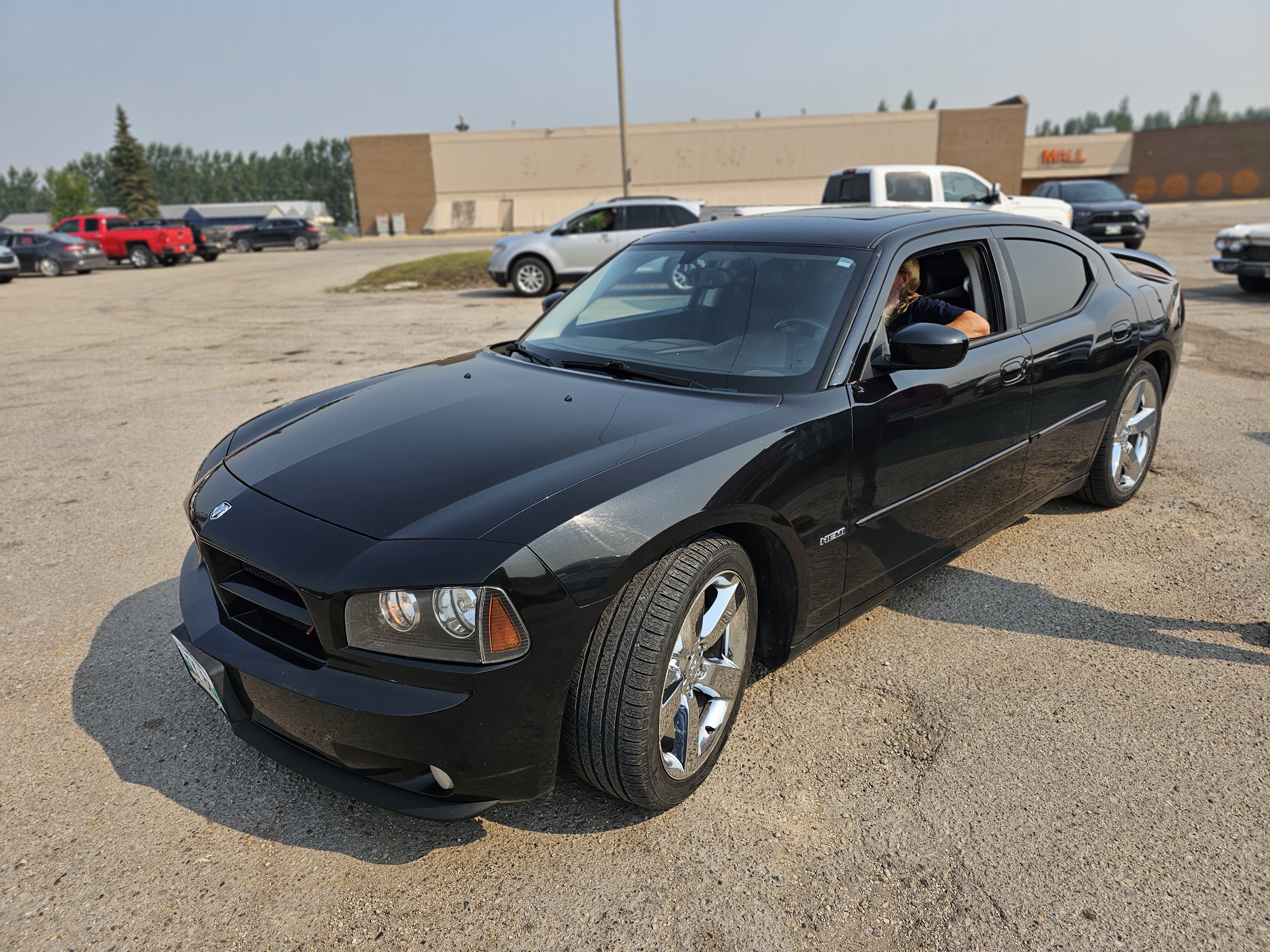 A modern black Dodge Charger, demonstrating the breadth of vehicles in the group.
