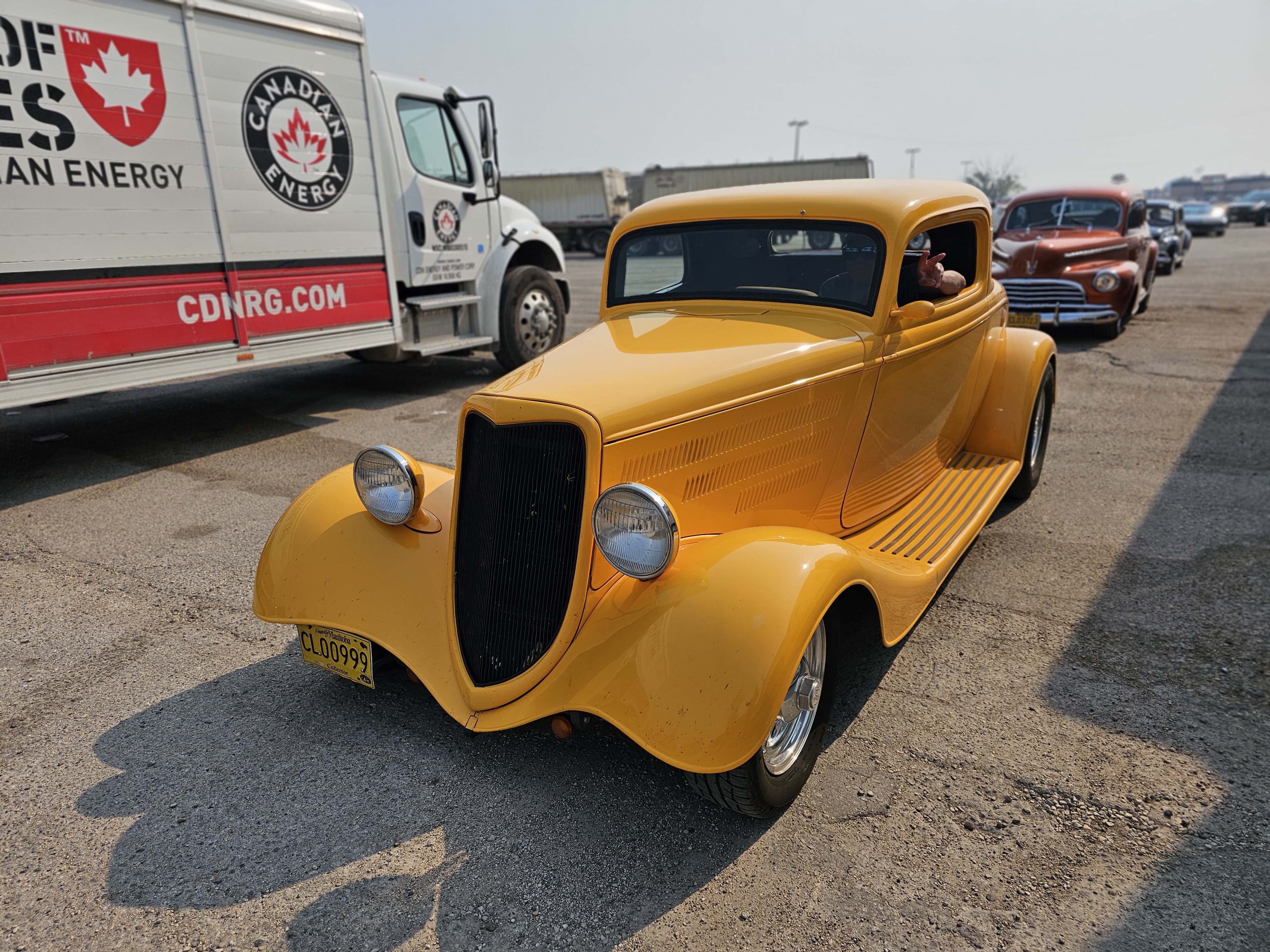 A bright yellow 1934 Ford Coupe, a quintessential hot rod.