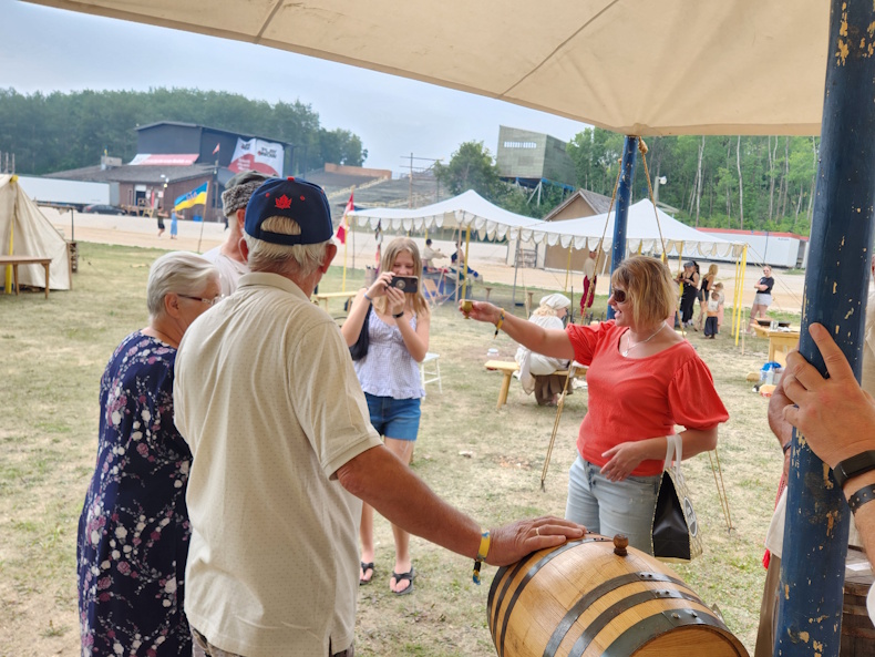Cheers and smiles under the festival tent, visitors enjoy a taste of tradition straight from the barrel at this lively cultural gathering.    PortageOnline/ Tristen Sokolosky