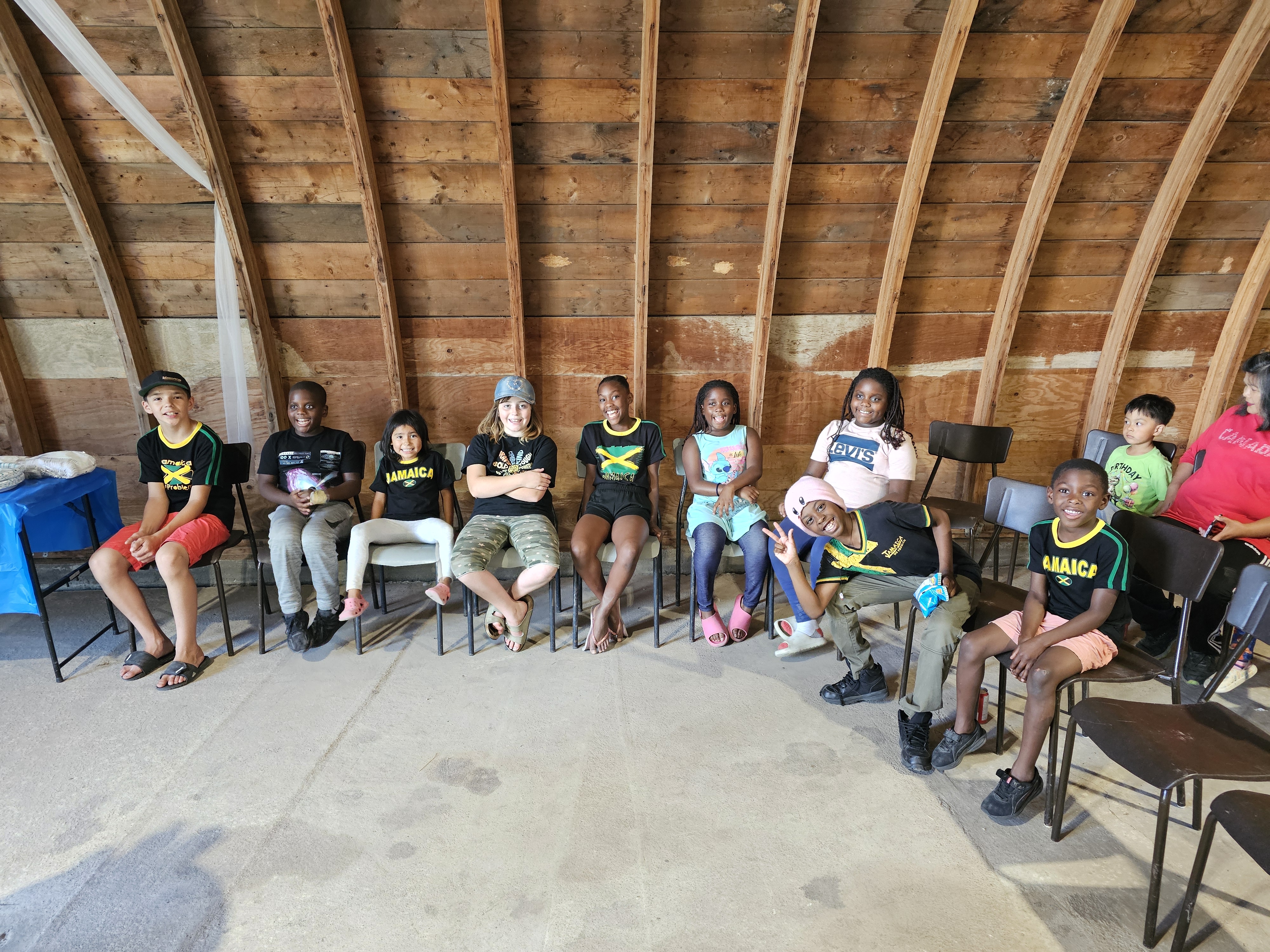 The children in the program are eager to dig into some celebratory chicken dinner