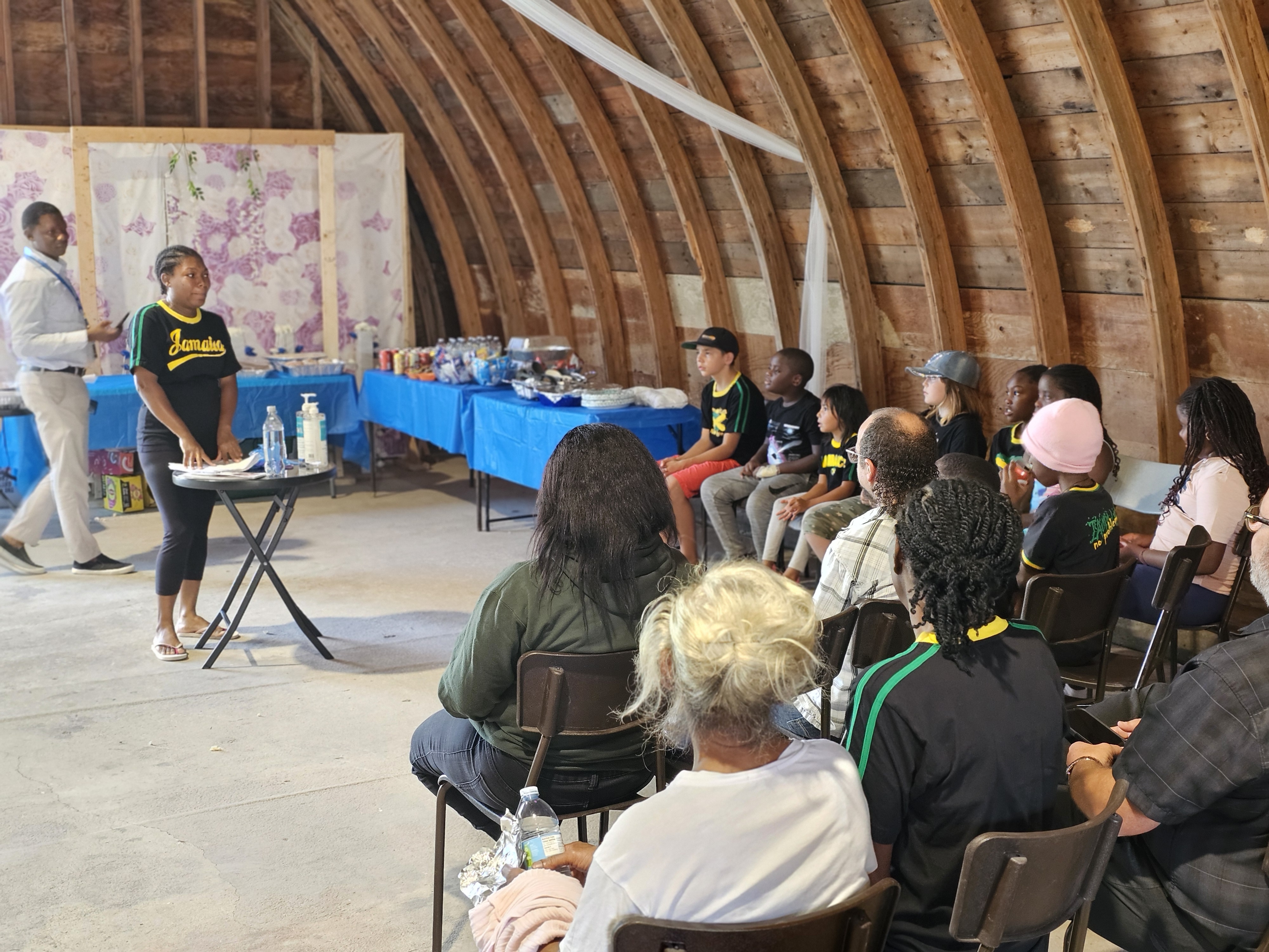 Lewis addresses the children and parents, recapping what they learned throughout the program.