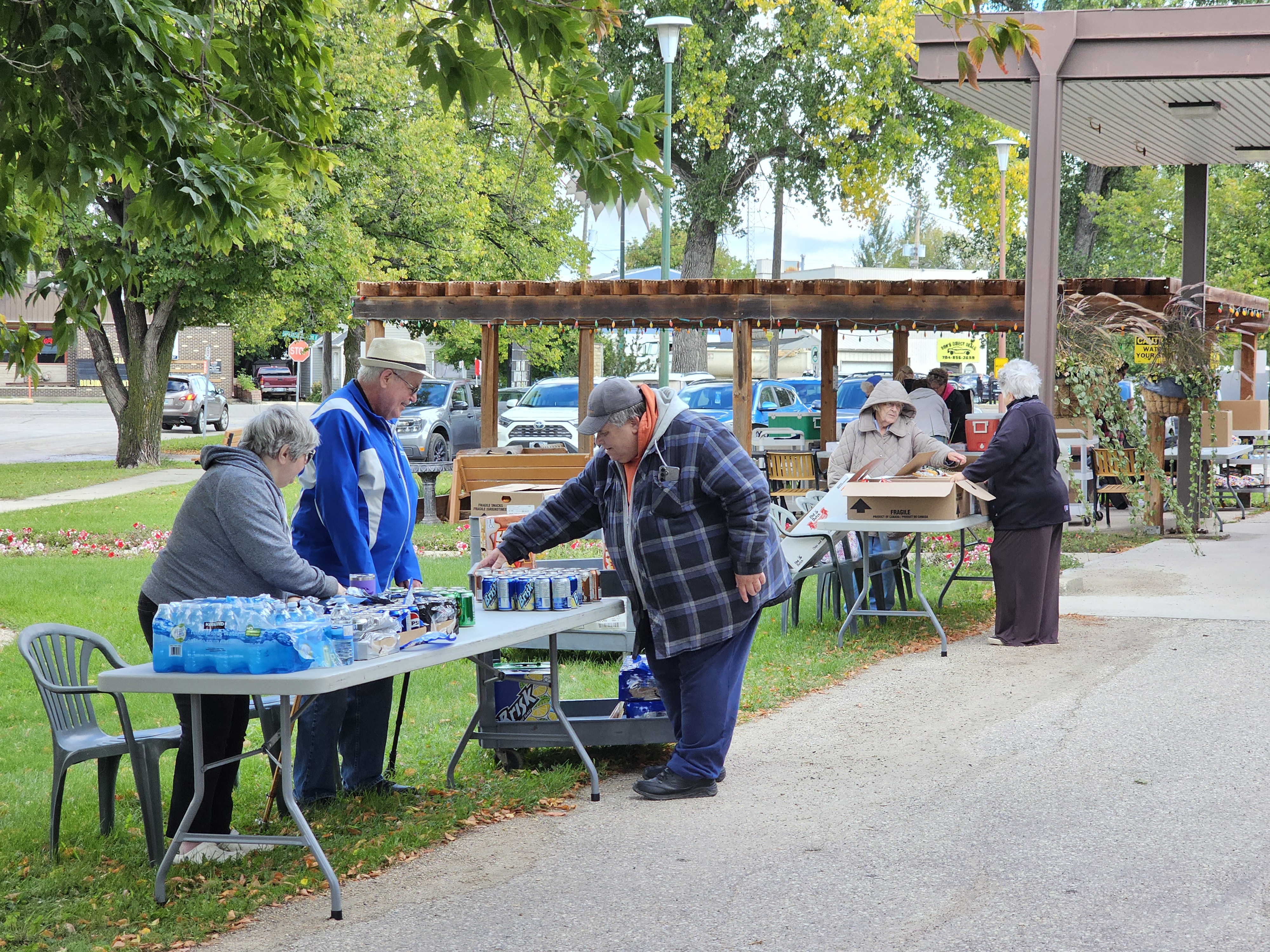 Volunteers managing the different tables where people could come through and pick up their chips, cookies, and drinks after purchasing a hot dog lunch combo