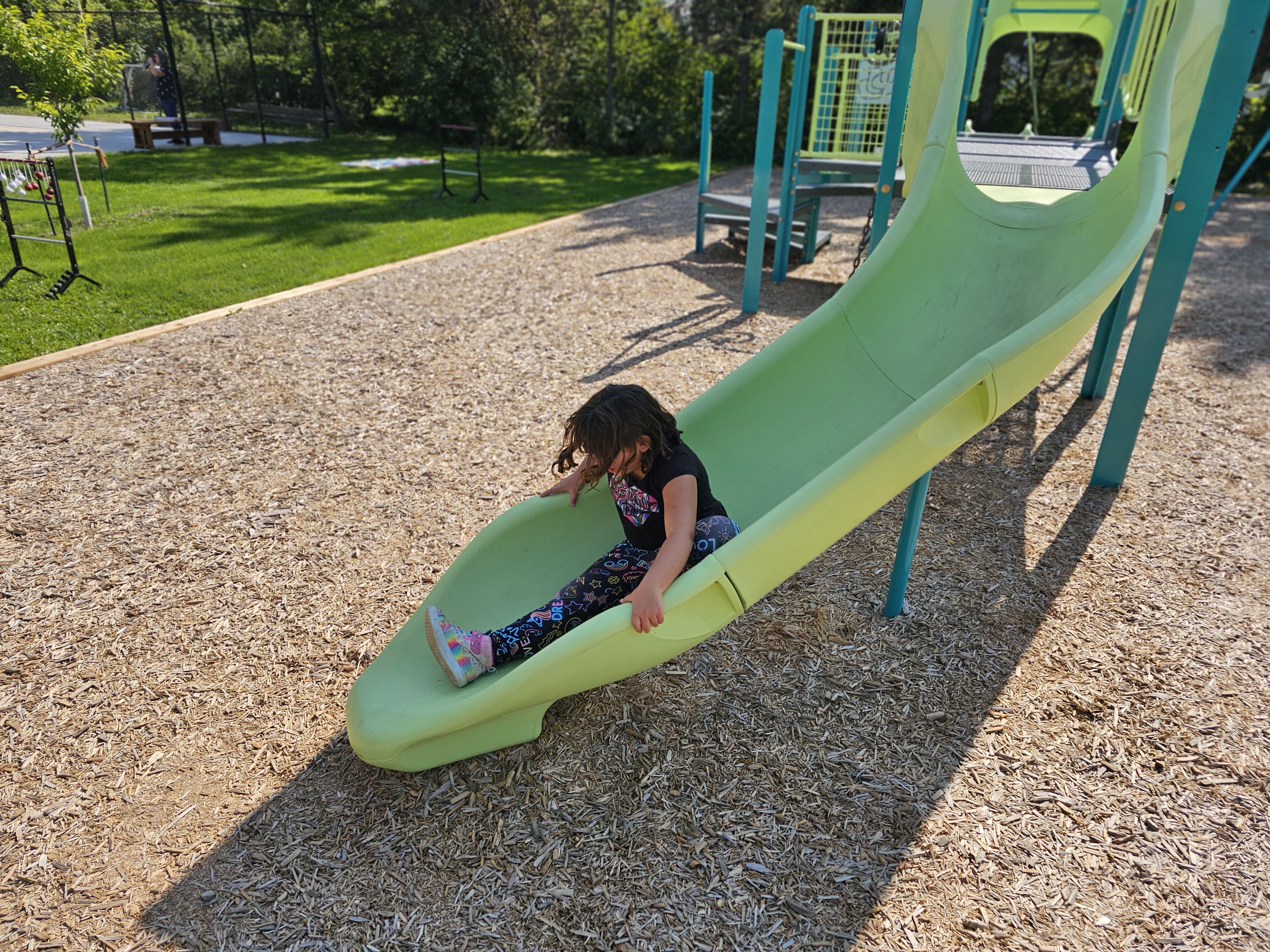 A young child going down the new slide at Peony Farm park