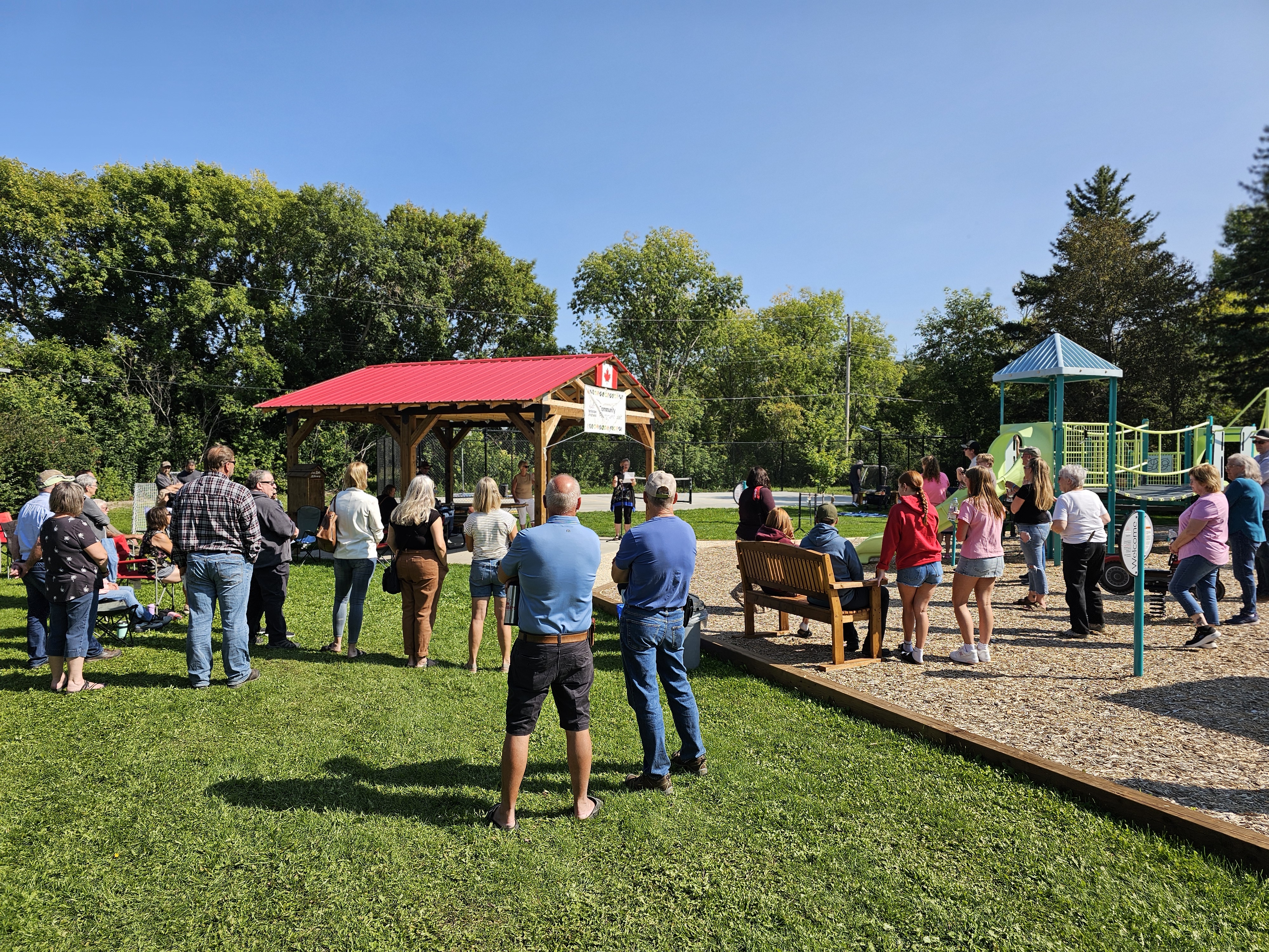 Attendees gather to listen to speeches from local community members and partners who helped make the new park possible