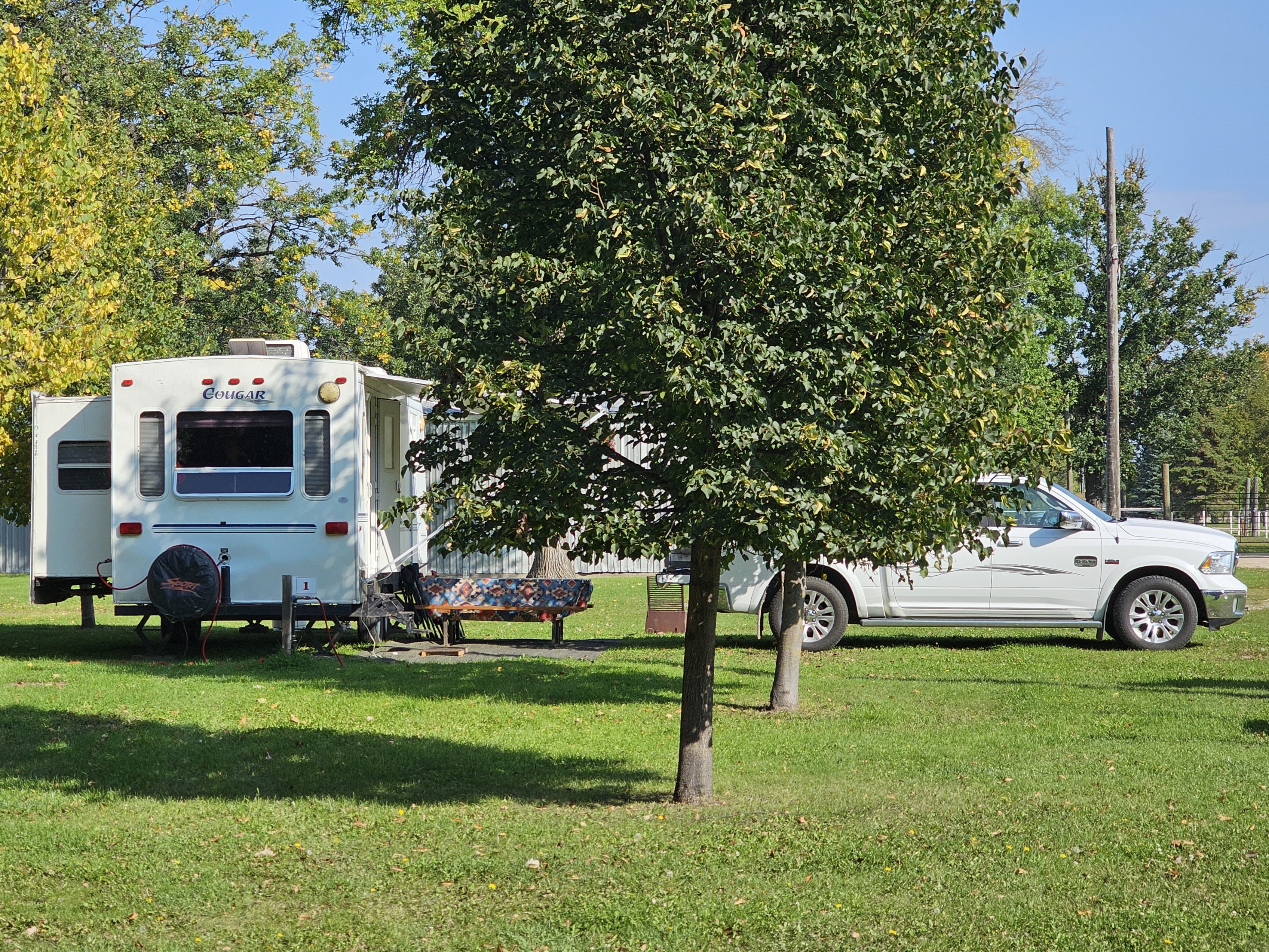 A camper and truck parked in one of the spots at the Portage Industrial Exhibition Campgrounds.
