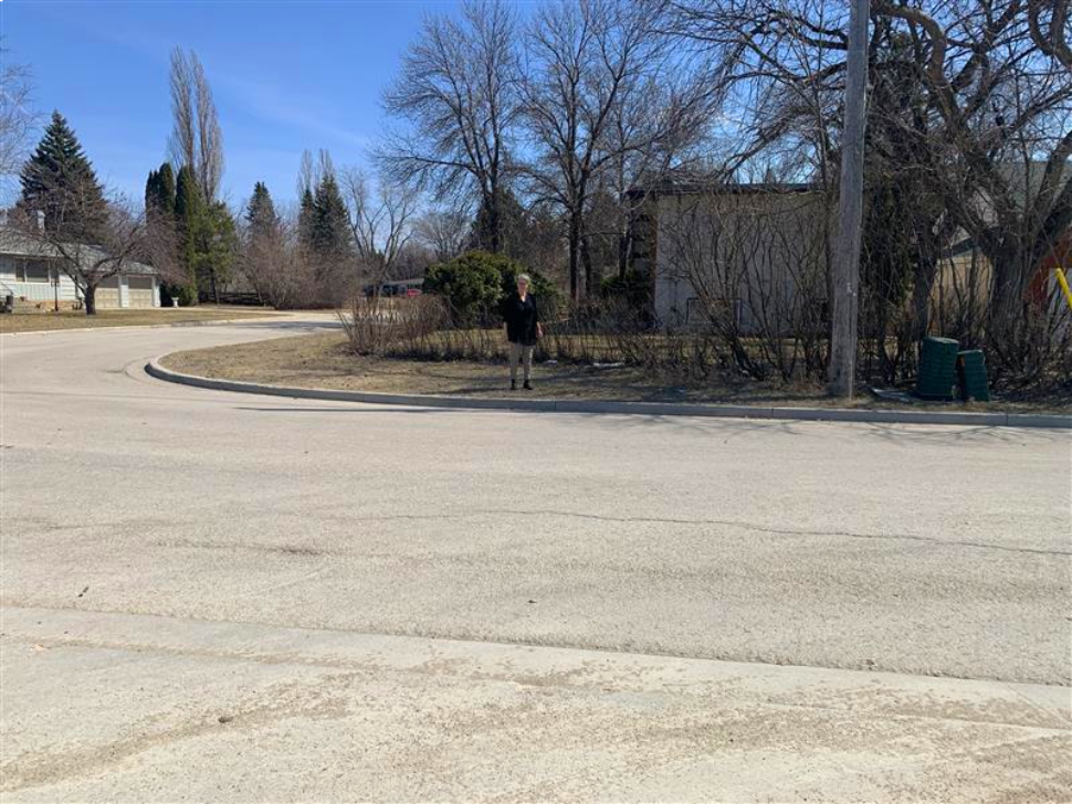marge thiessen stands where she would like to see a cement pad for students to cross onto as they walk to and from school