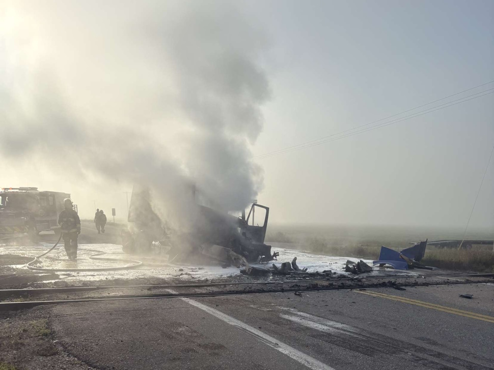 Burnt semi-truck remains on Highway 23 following a collision with a train near Dufrost.