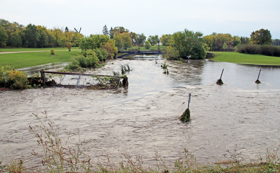 Downed fencing around the overflowing MHV pond after last Friday's heavy rainfall event.