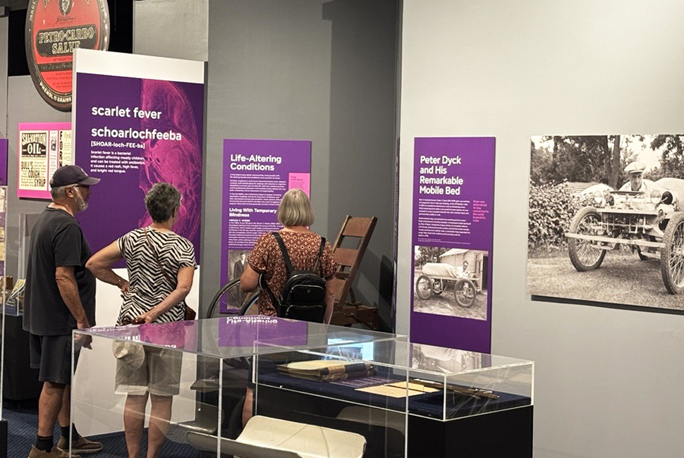 Visitors inside the newly opened Gerhard Enns Gallery Exhibit "Mennonite Medicine"