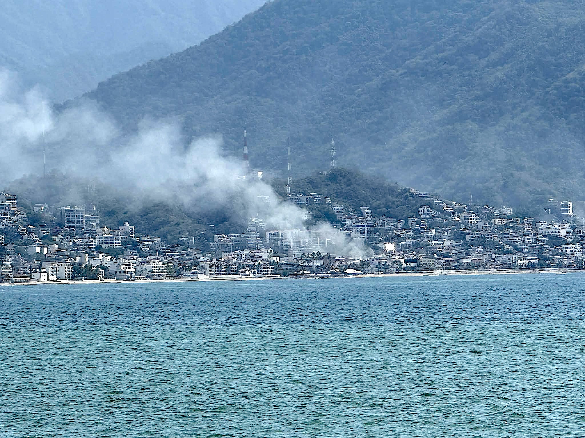 smoke in the distance over a beach