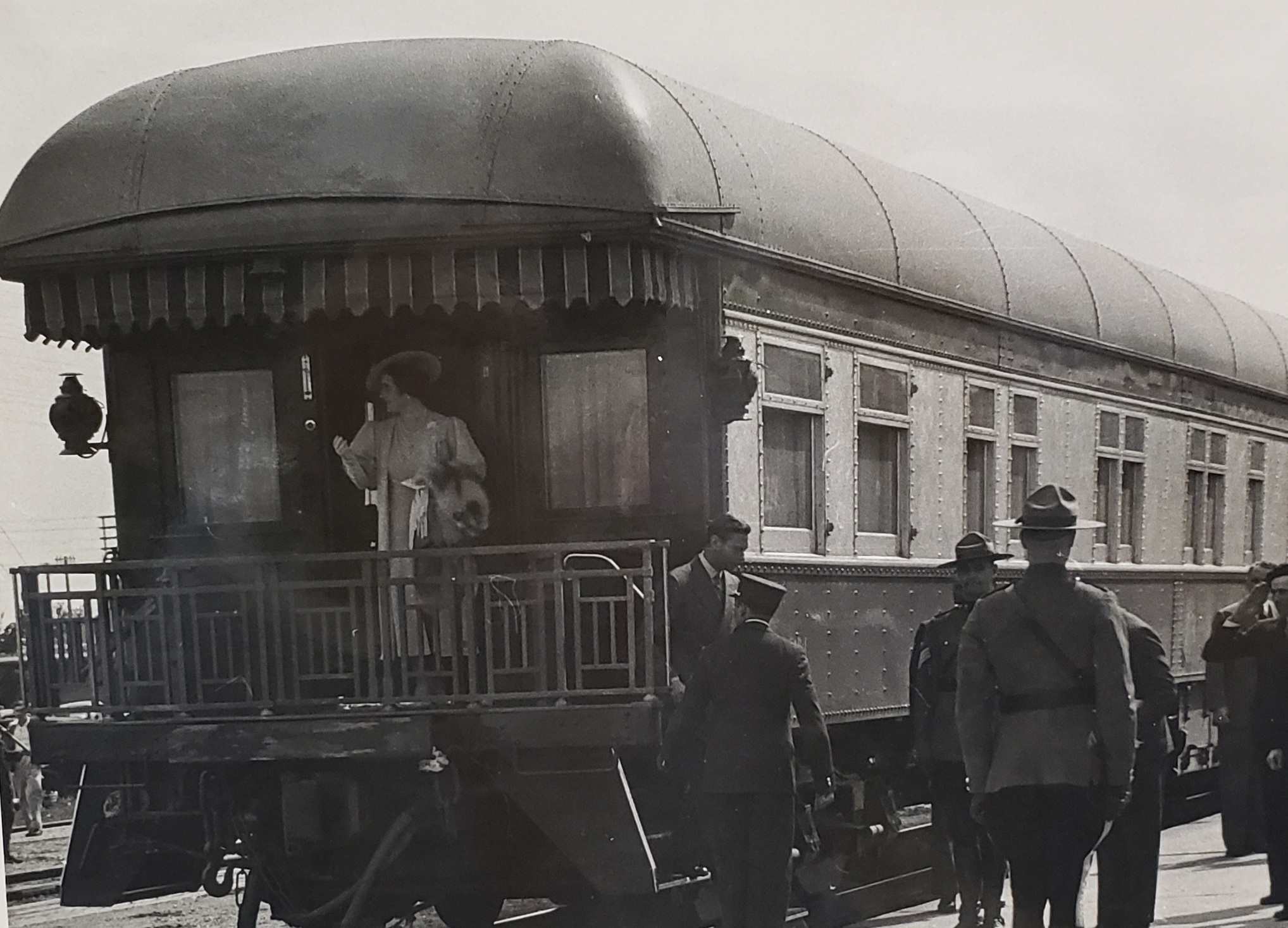 Queen Elizabeth II stands at the caboose of the train as it travels through Portage la Prairie.